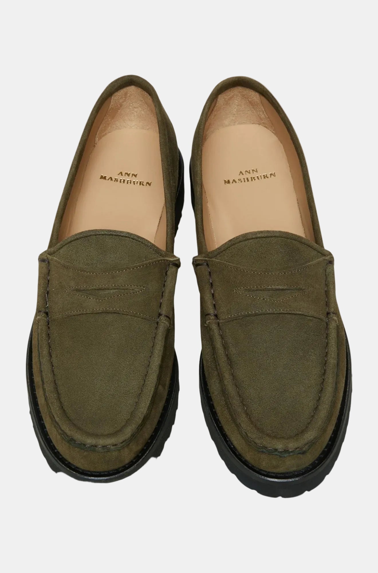 A pair of navy blue suede loafers with a lug sole.