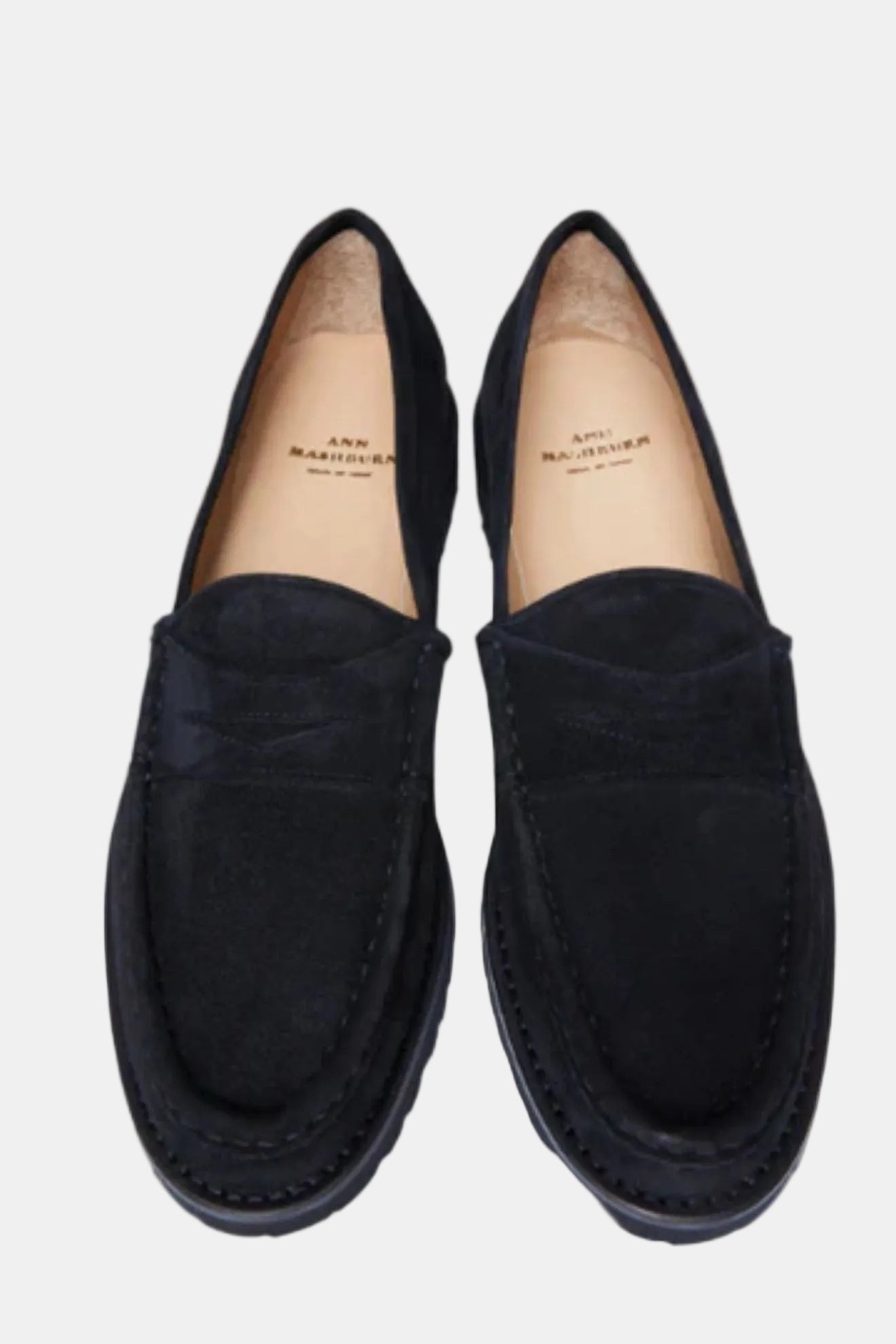 A pair of black suede penny loafers shown from a top-down view on a plain white background. The brand name 'ANNO MARZIERO' is visible on the tan insoles.