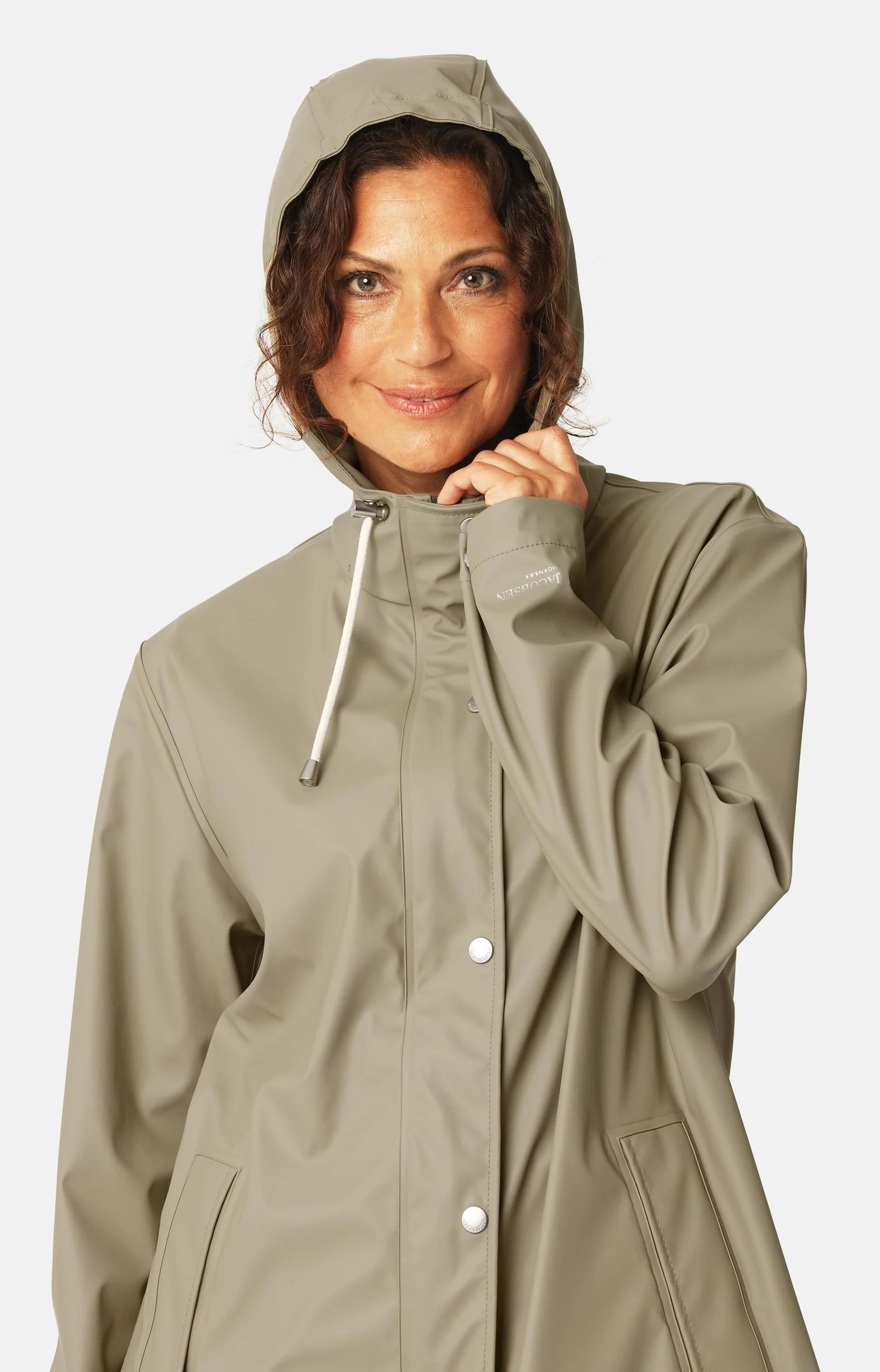 Woman wearing a beige raincoat on a white background