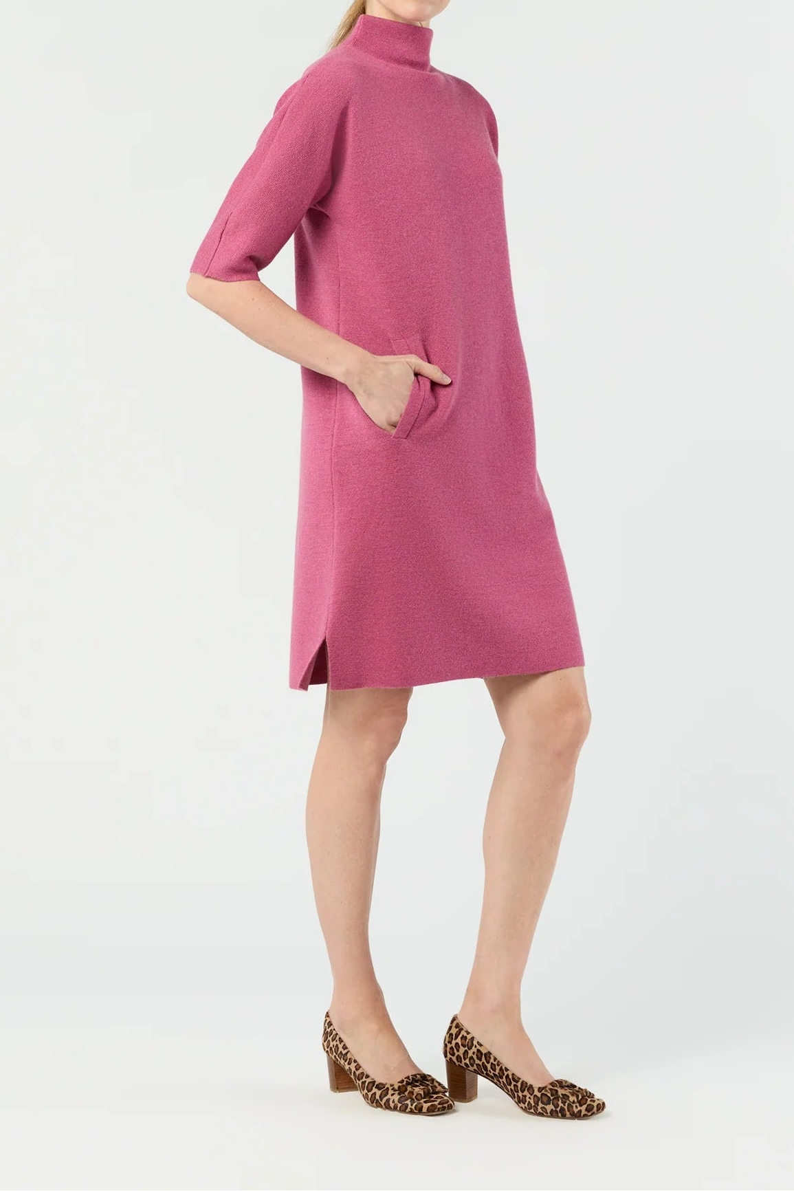 Woman wearing a pink dress with a white background