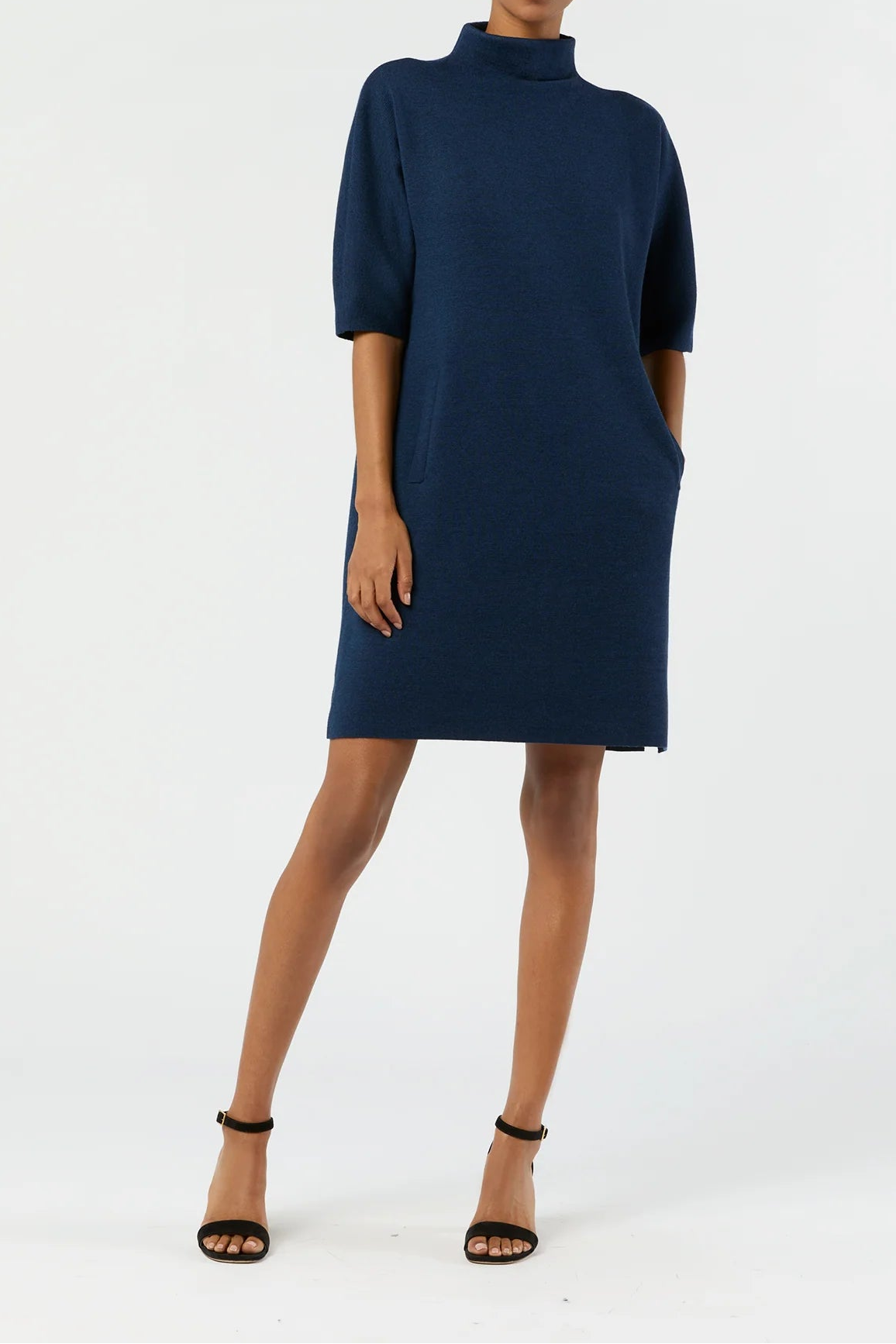 Woman wearing a navy blue dress on a white background