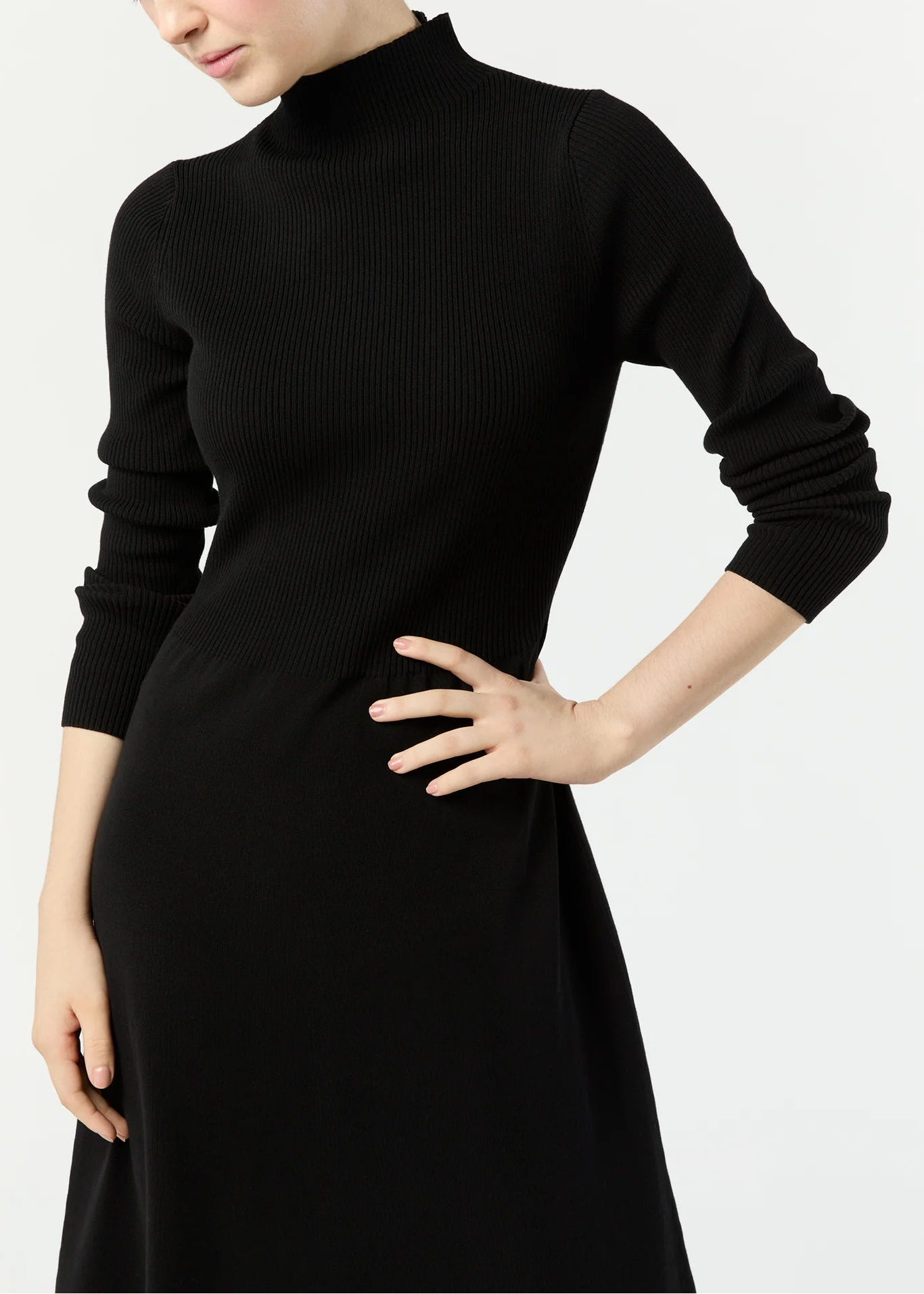 Woman wearing a black dress with a plain background