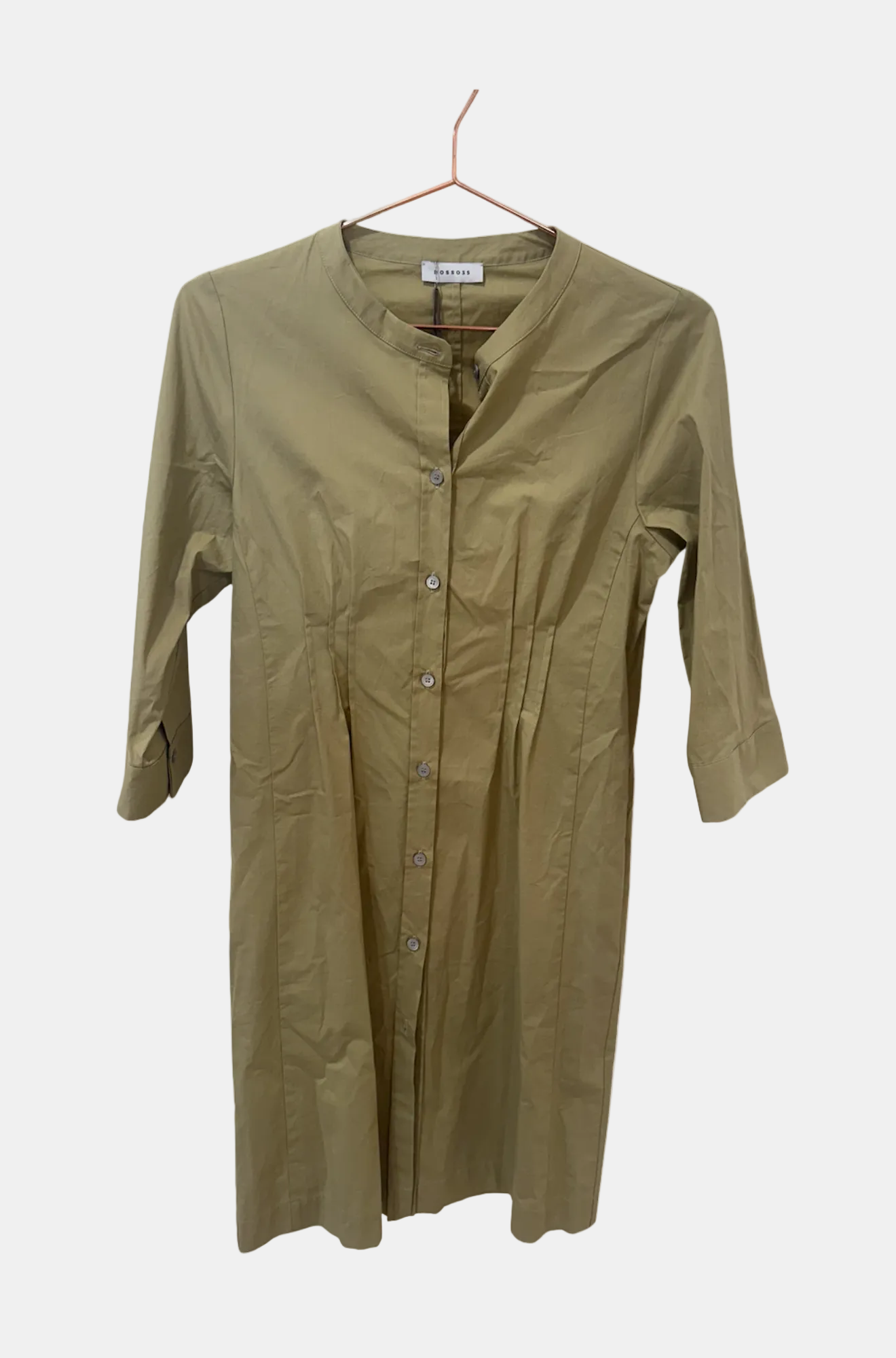 Green shirt on a hanger against a white background