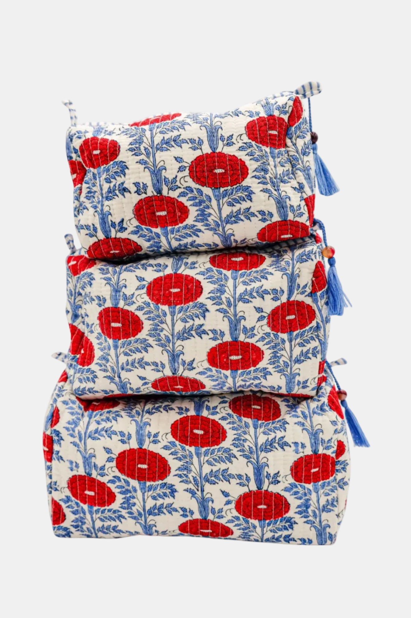 Stack of fabric bags with red floral pattern on a white background
