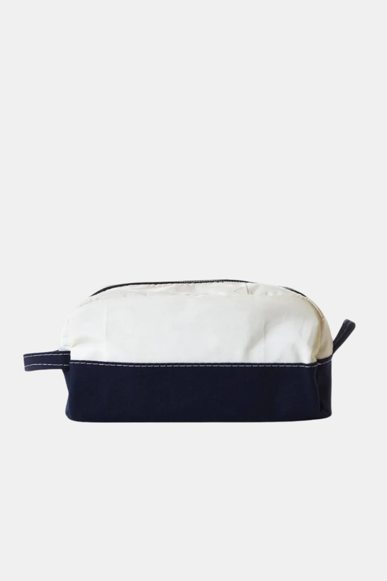White toiletry bag with navy blue trim on a white background