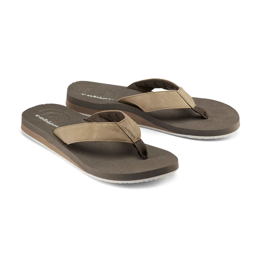 Pair of brown and beige sandals on a white background