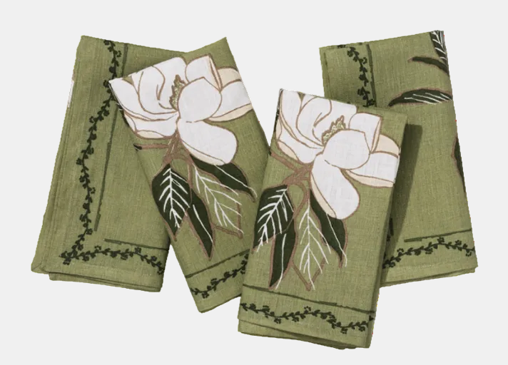 Set of four green napkins with floral patterns on a white background