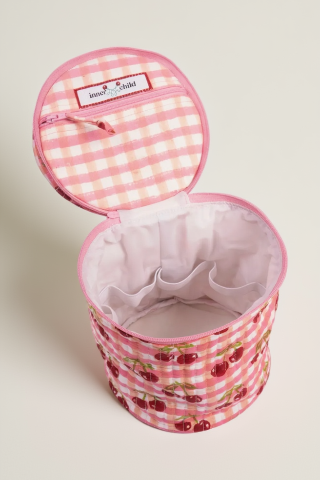 Pink checkered fabric basket with cherry design on a white background