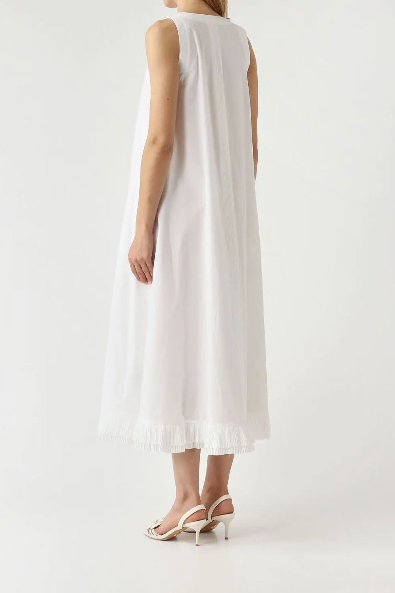 White sleeveless dress worn by a person on a white background
