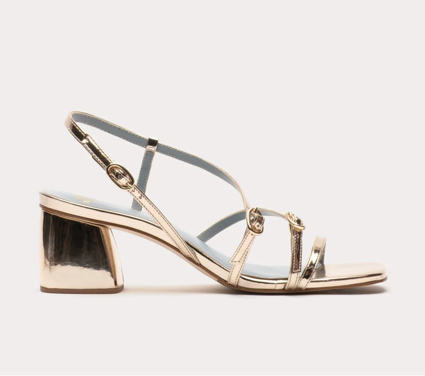 Gold high-heeled sandal on a white background