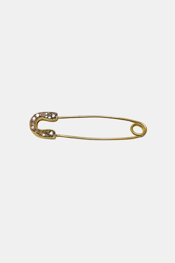 A gold safety pin brooch embellished with small clear rhinestones along the curved left side, shown on a plain white background.