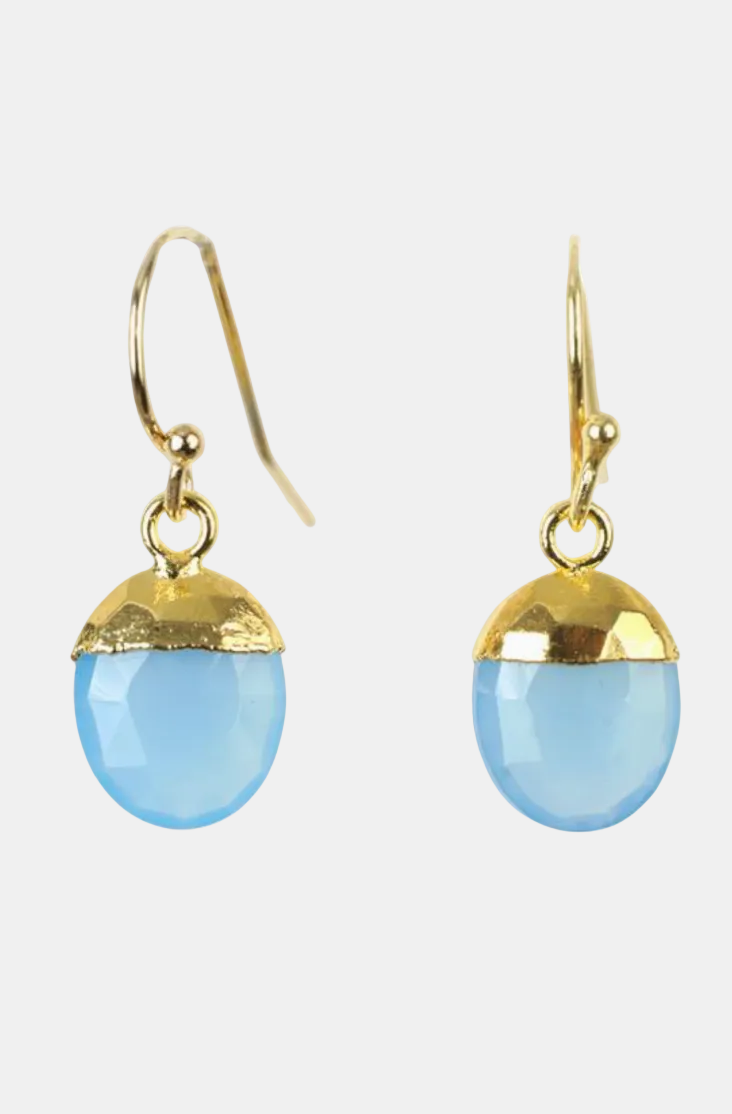 A pair of gold-tone dangle earrings with faceted light blue oval drops, shown against a plain white background.