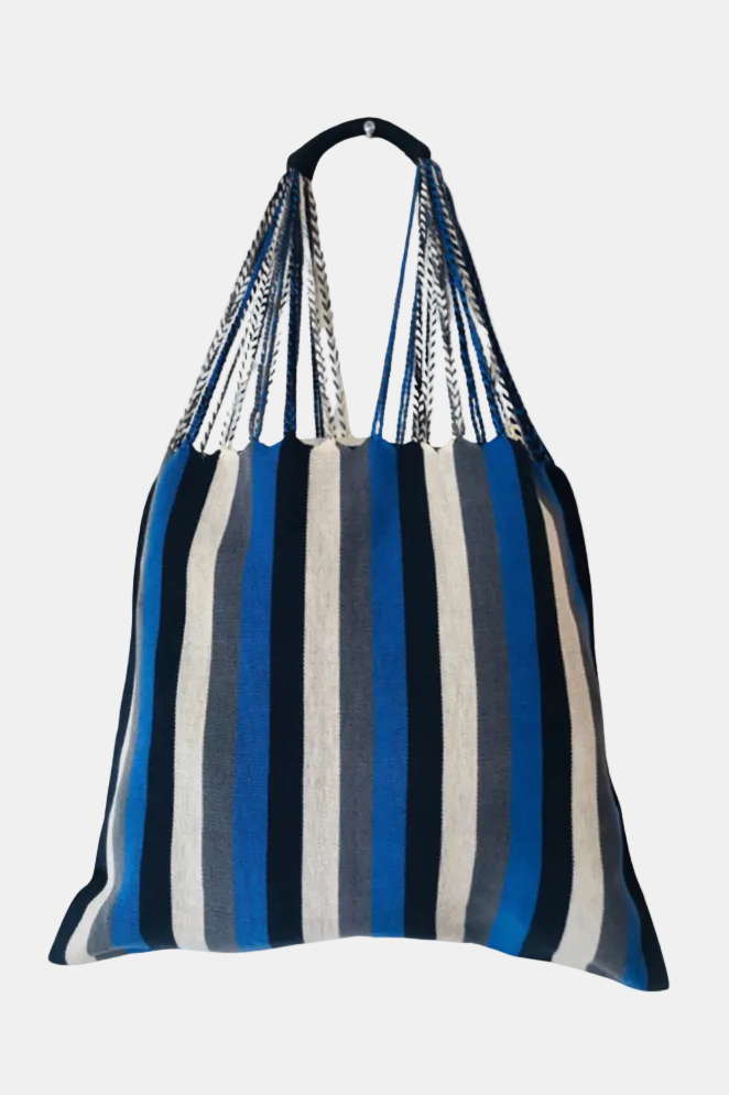 A striped fabric shoulder bag with vertical blue, navy, gray, and off-white stripes, featuring braided shoulder straps.