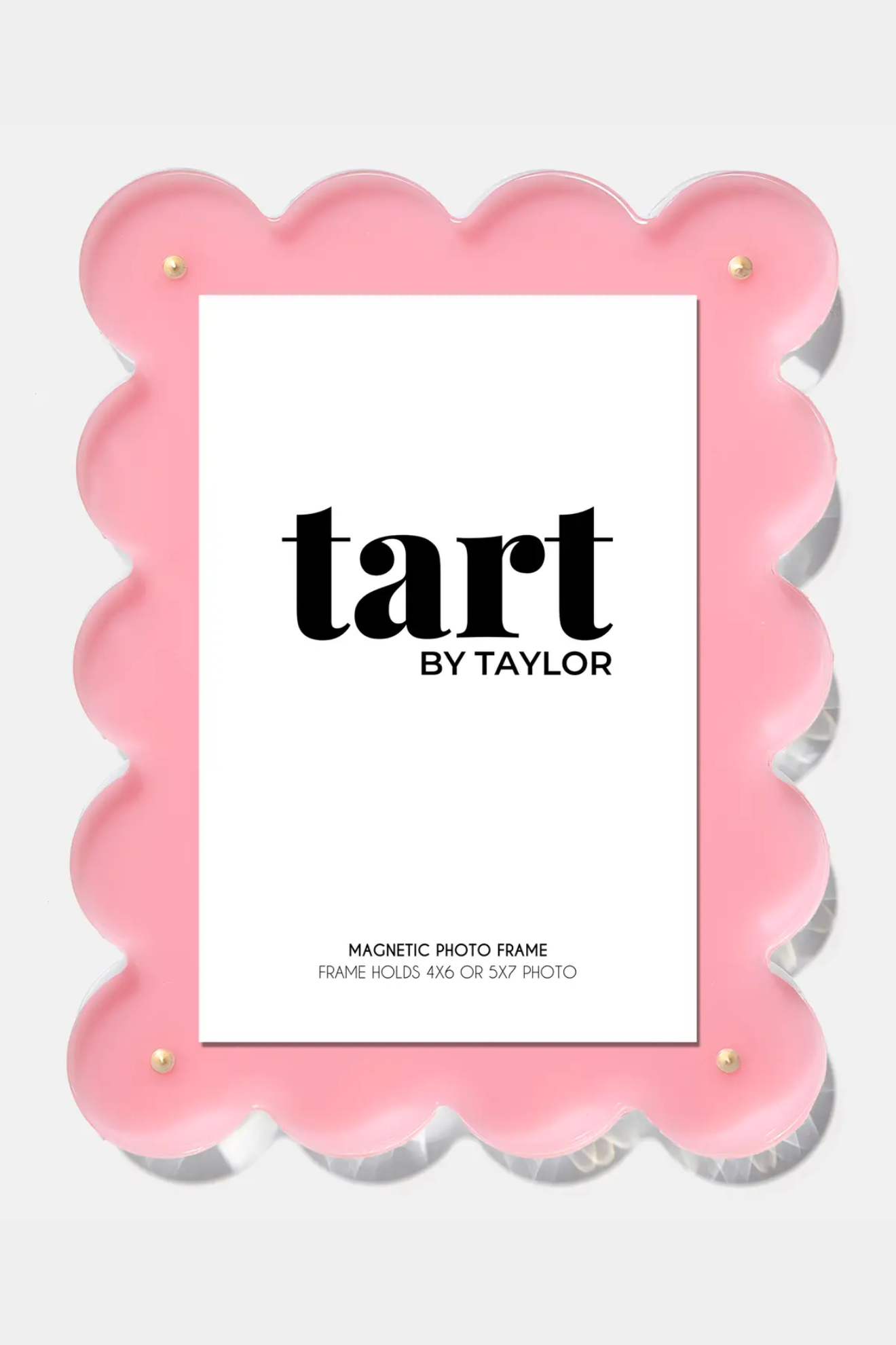 Pink scalloped photo frame with 'tart by Taylor' branding on a white background