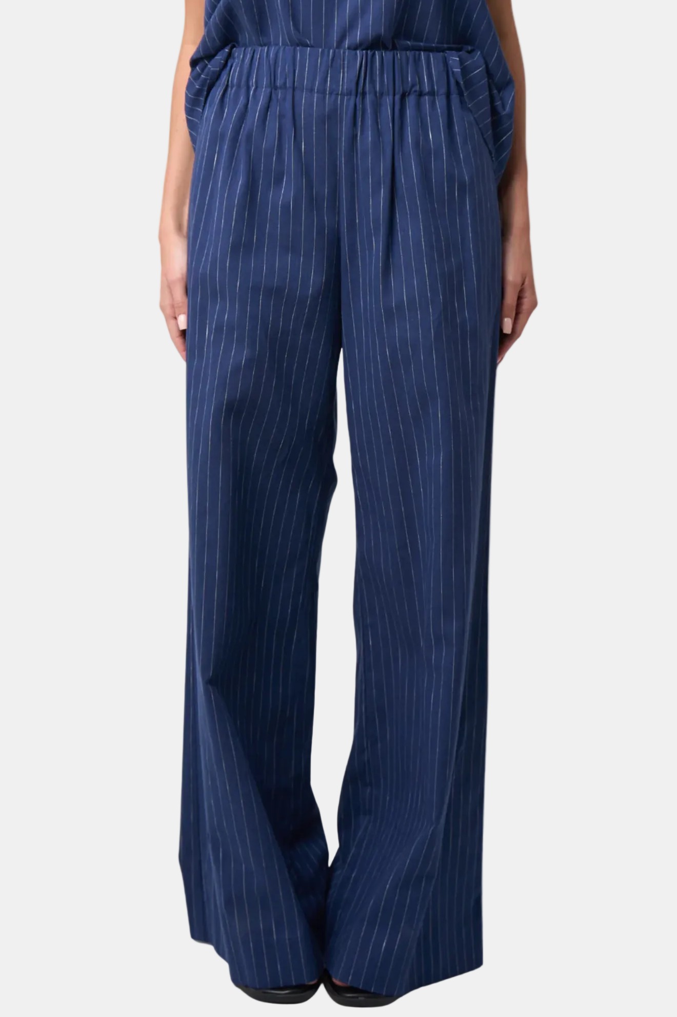 Navy pinstripe pants on a white background