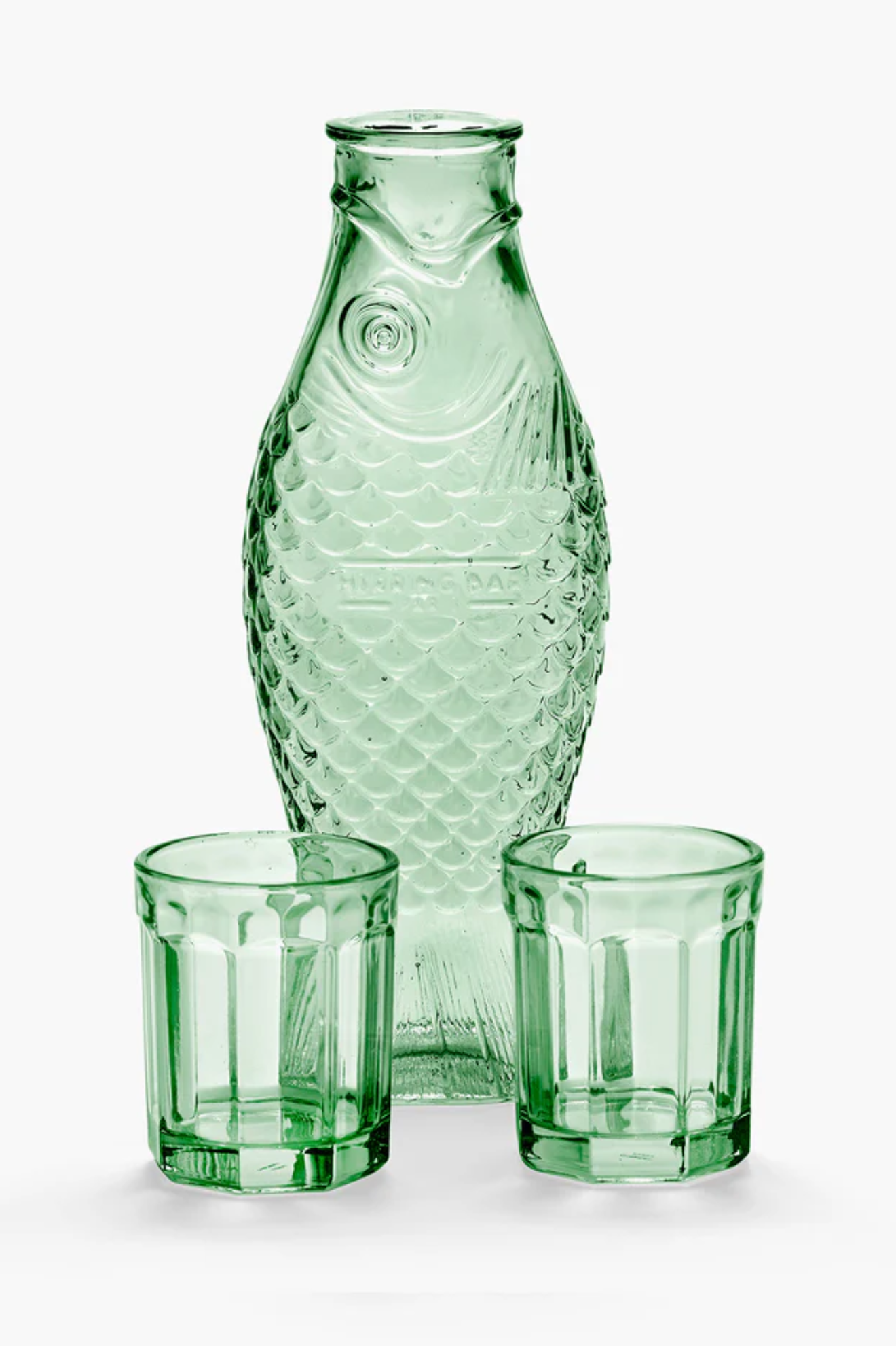Green glass carafe and two glasses on a white background