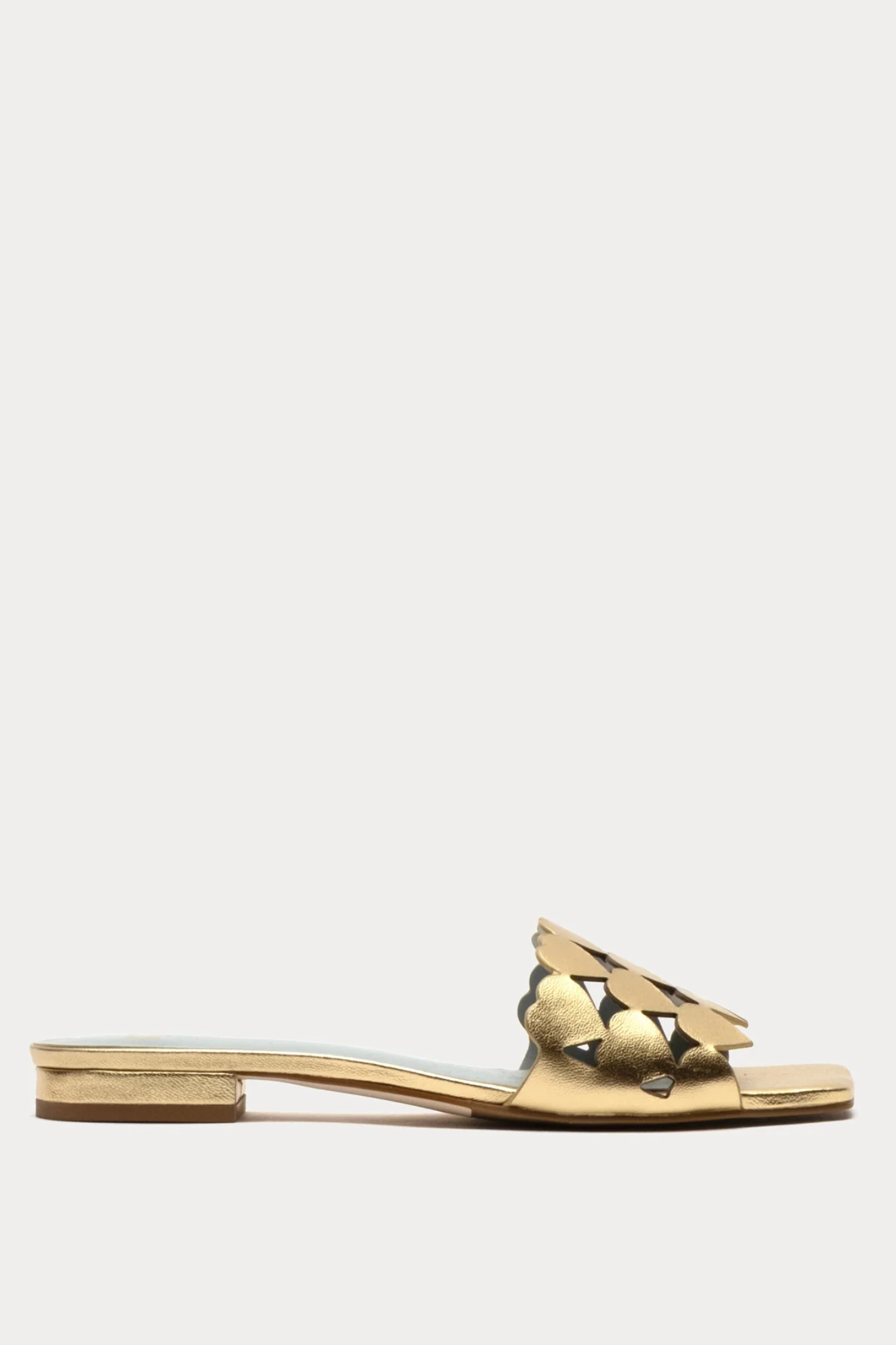 Gold sandal with star-shaped embellishments on a white background