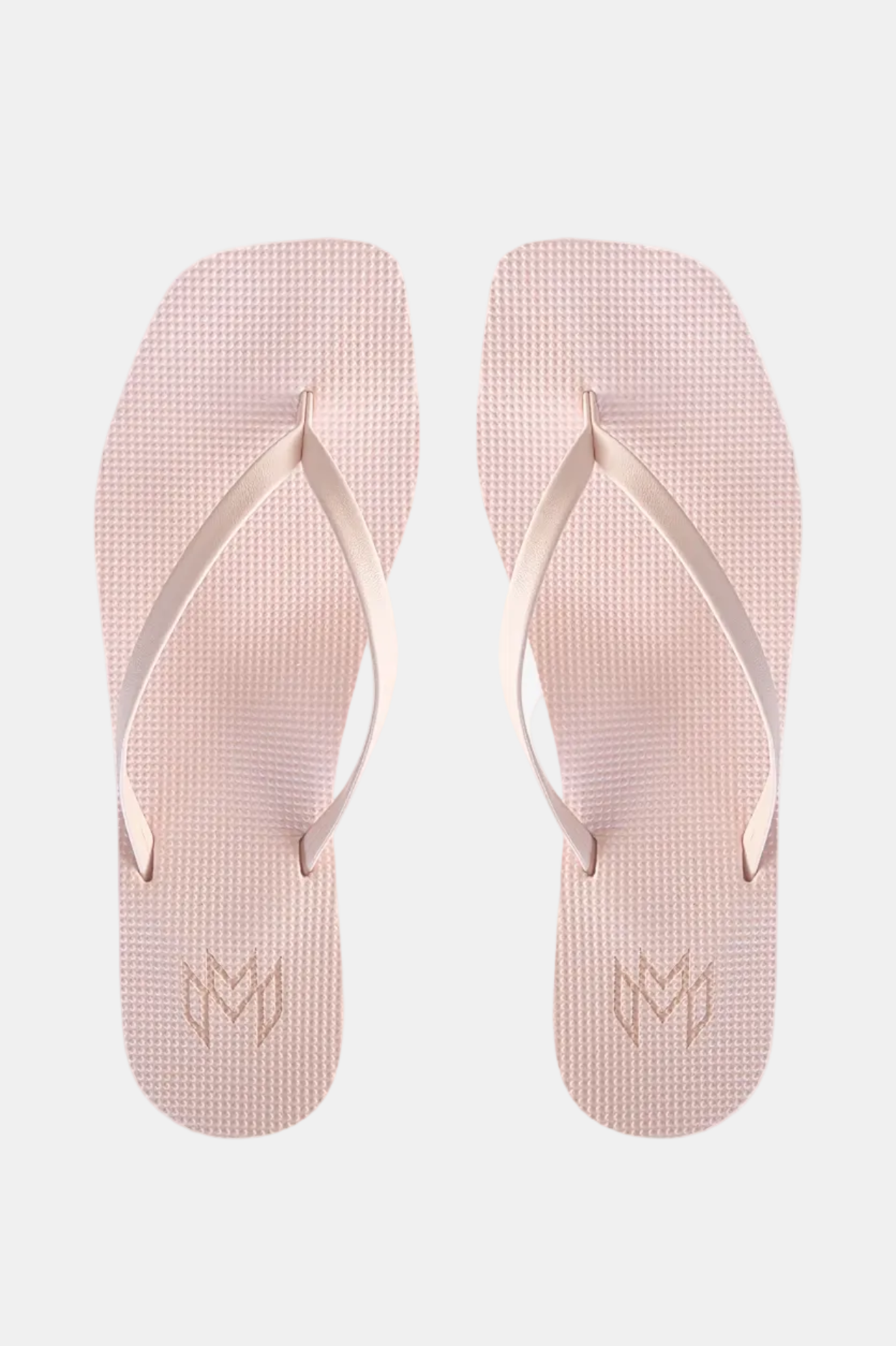 Pair of light pink flip-flops with a logo on a white background