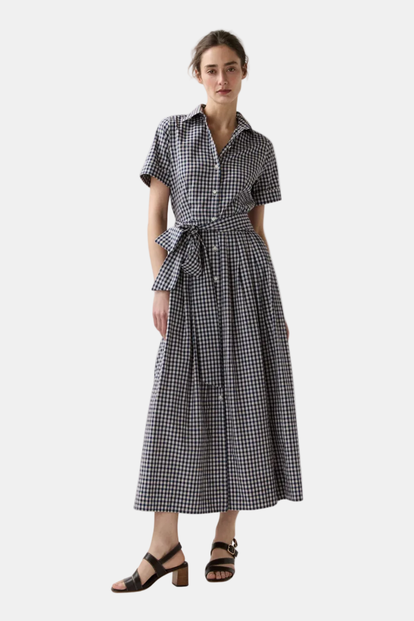 Woman wearing a black and white checkered dress on a white background