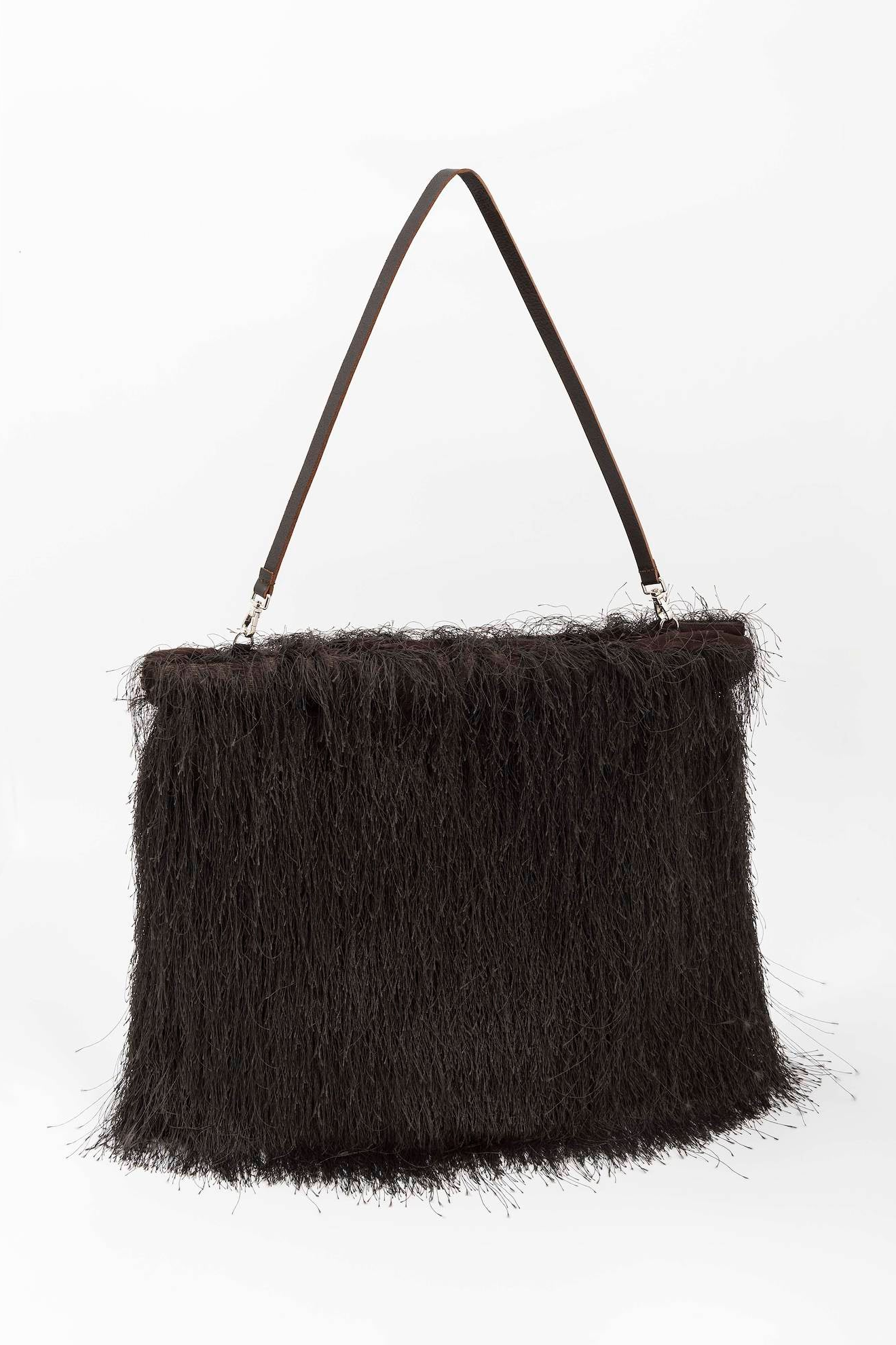 Black fluffy handbag with a strap on a white background