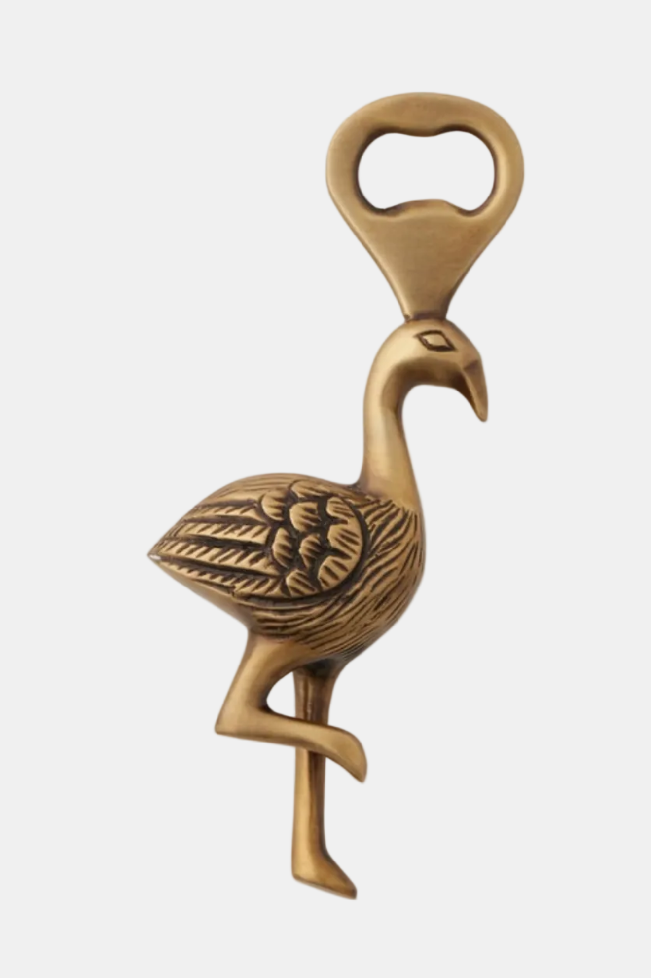 Brass flamingo bottle opener on a white background