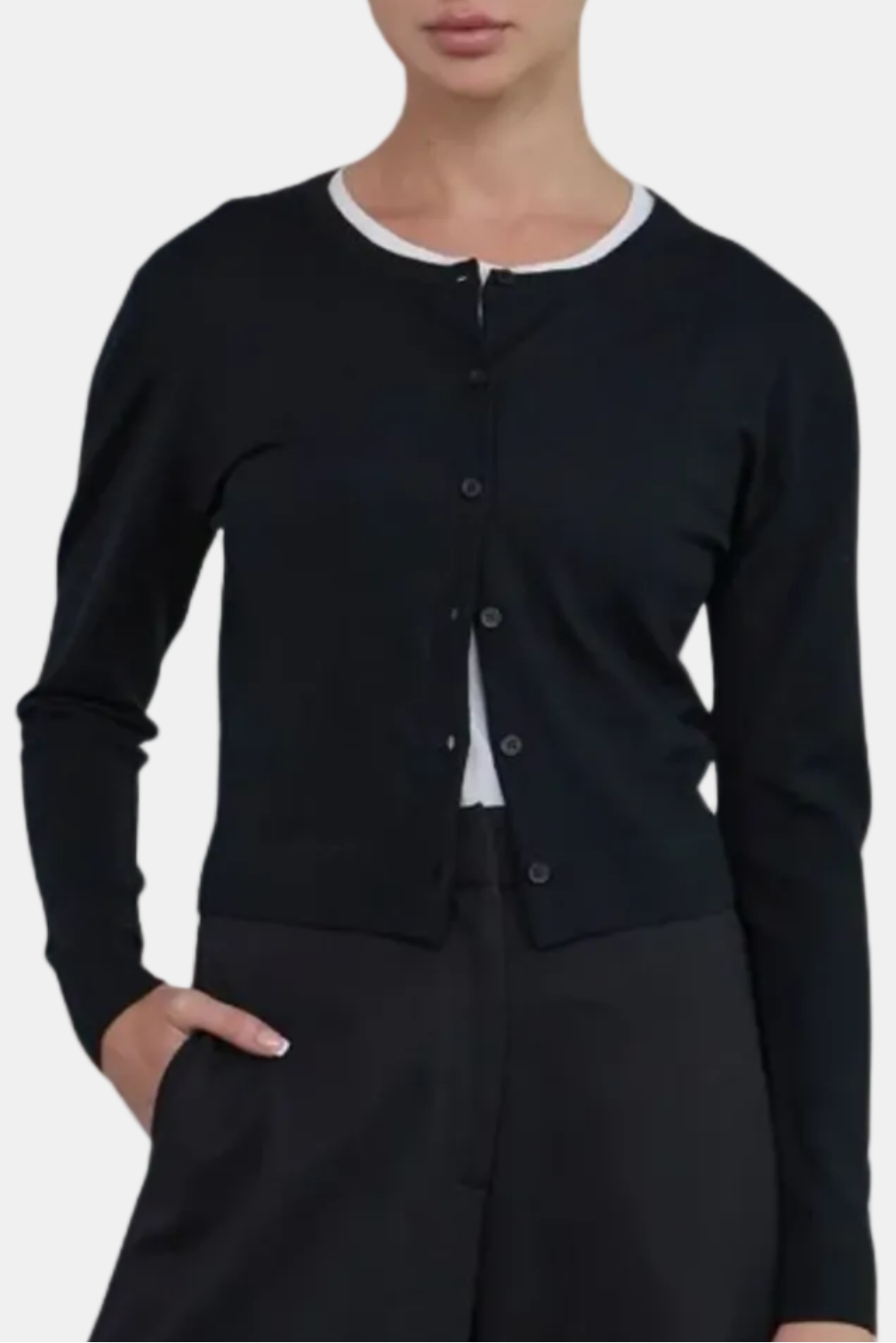 Woman wearing a black cardigan over a white shirt on a white background
