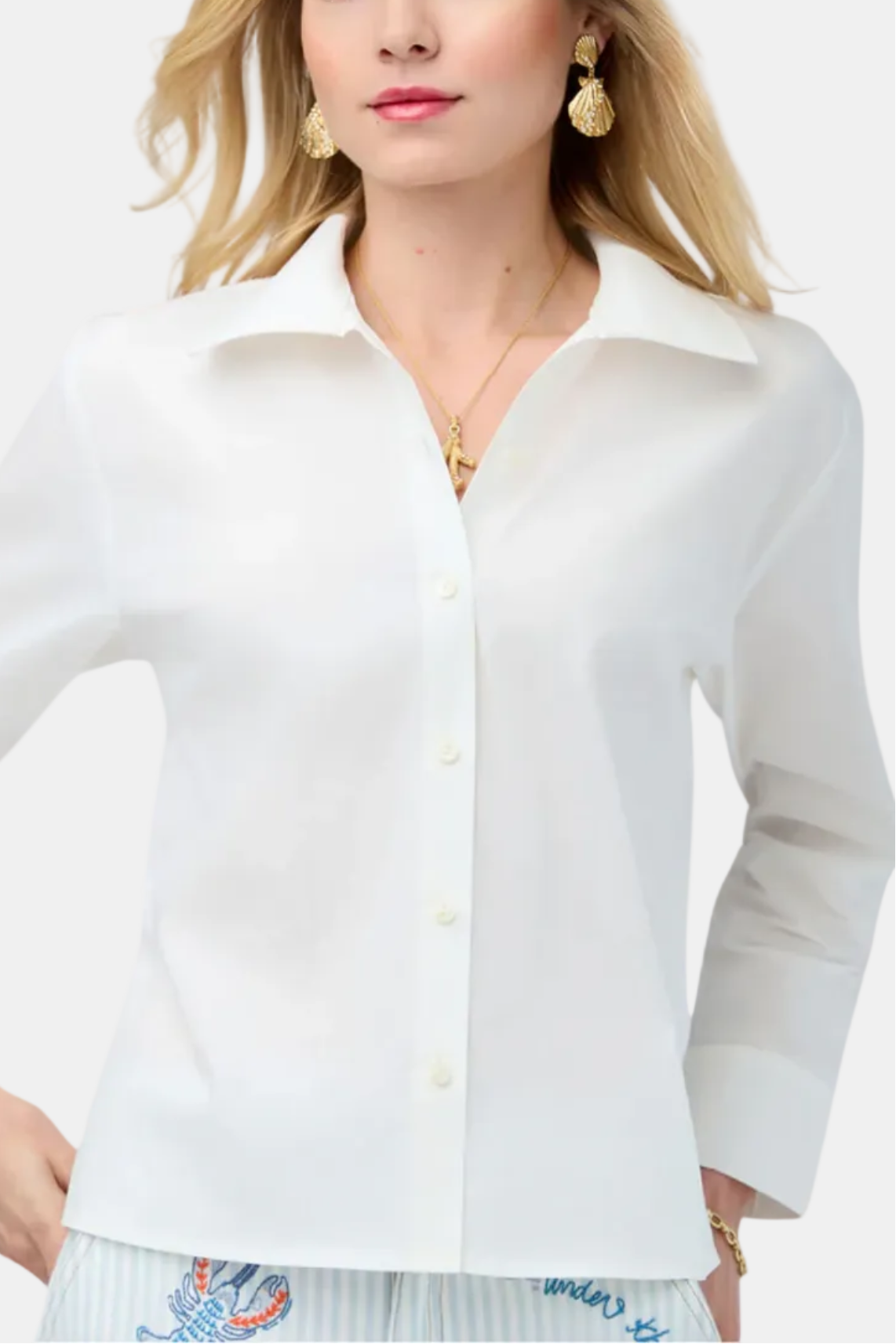 Woman wearing a white button-up shirt on a white background