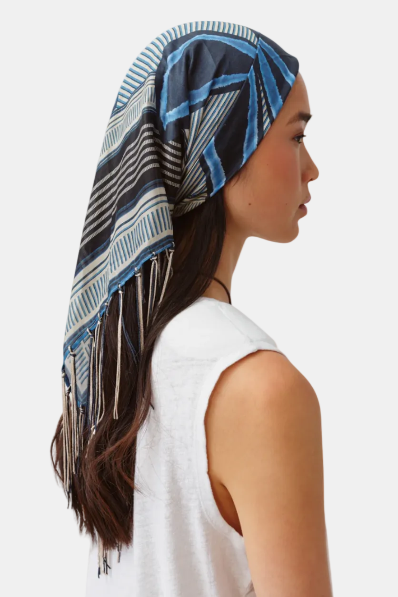 Woman wearing a patterned headscarf on a white background