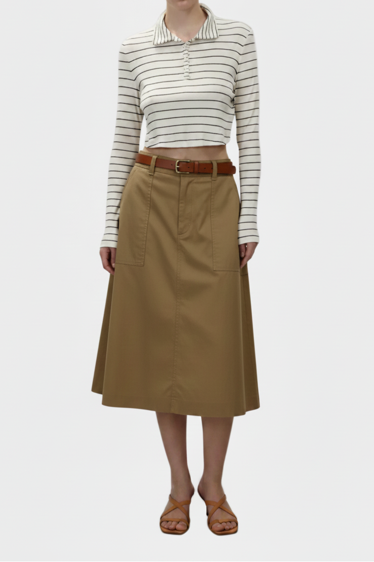 Woman wearing a striped shirt and beige skirt on a white background