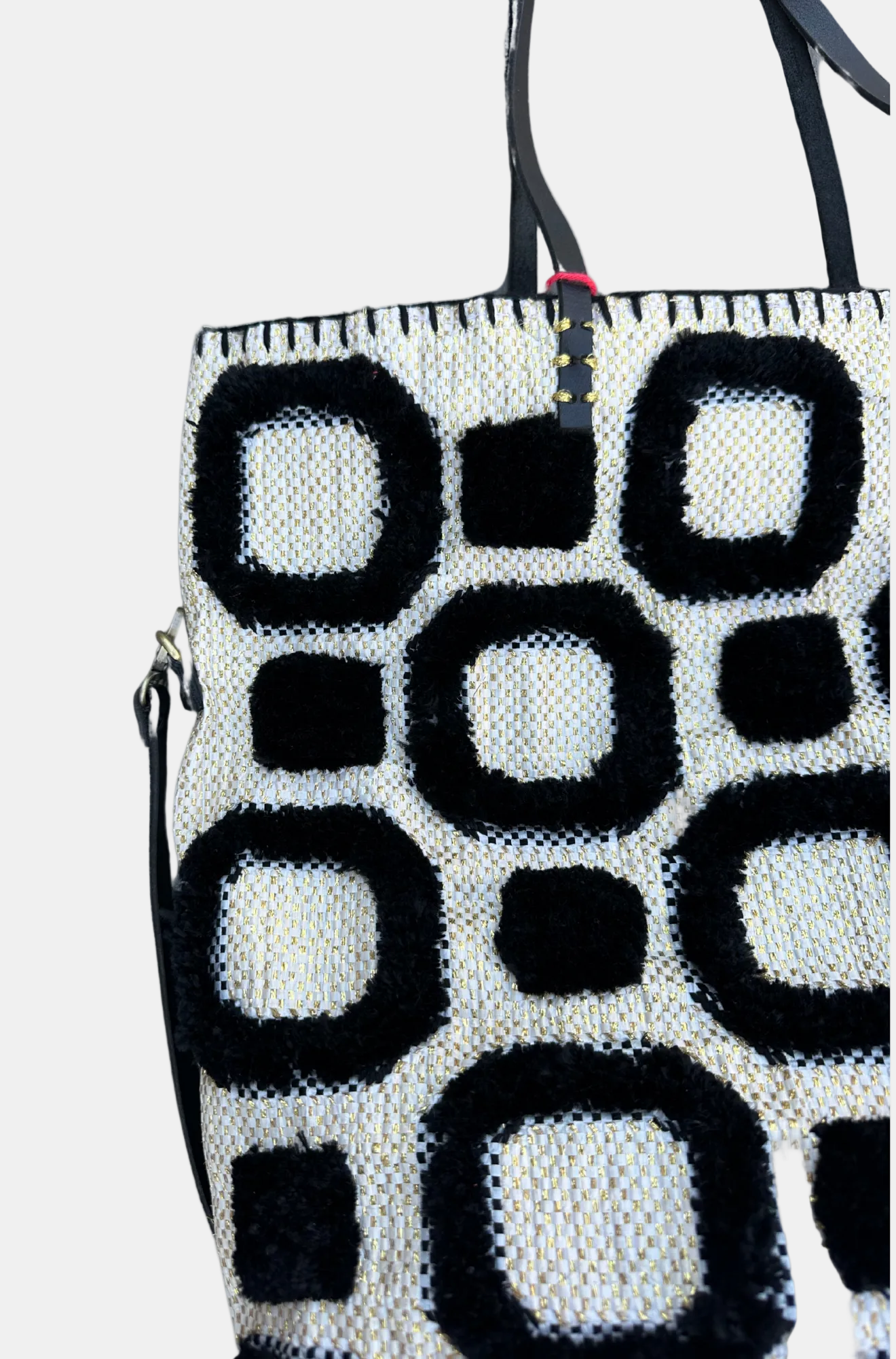 Black and white patterned bag with geometric design.