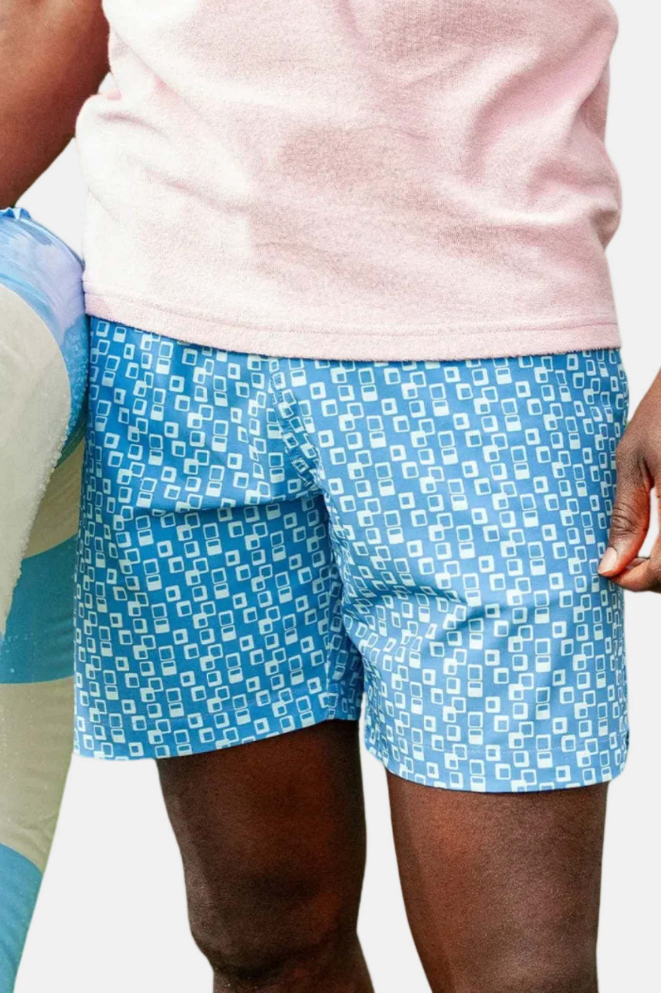 Person wearing blue patterned shorts with a white background