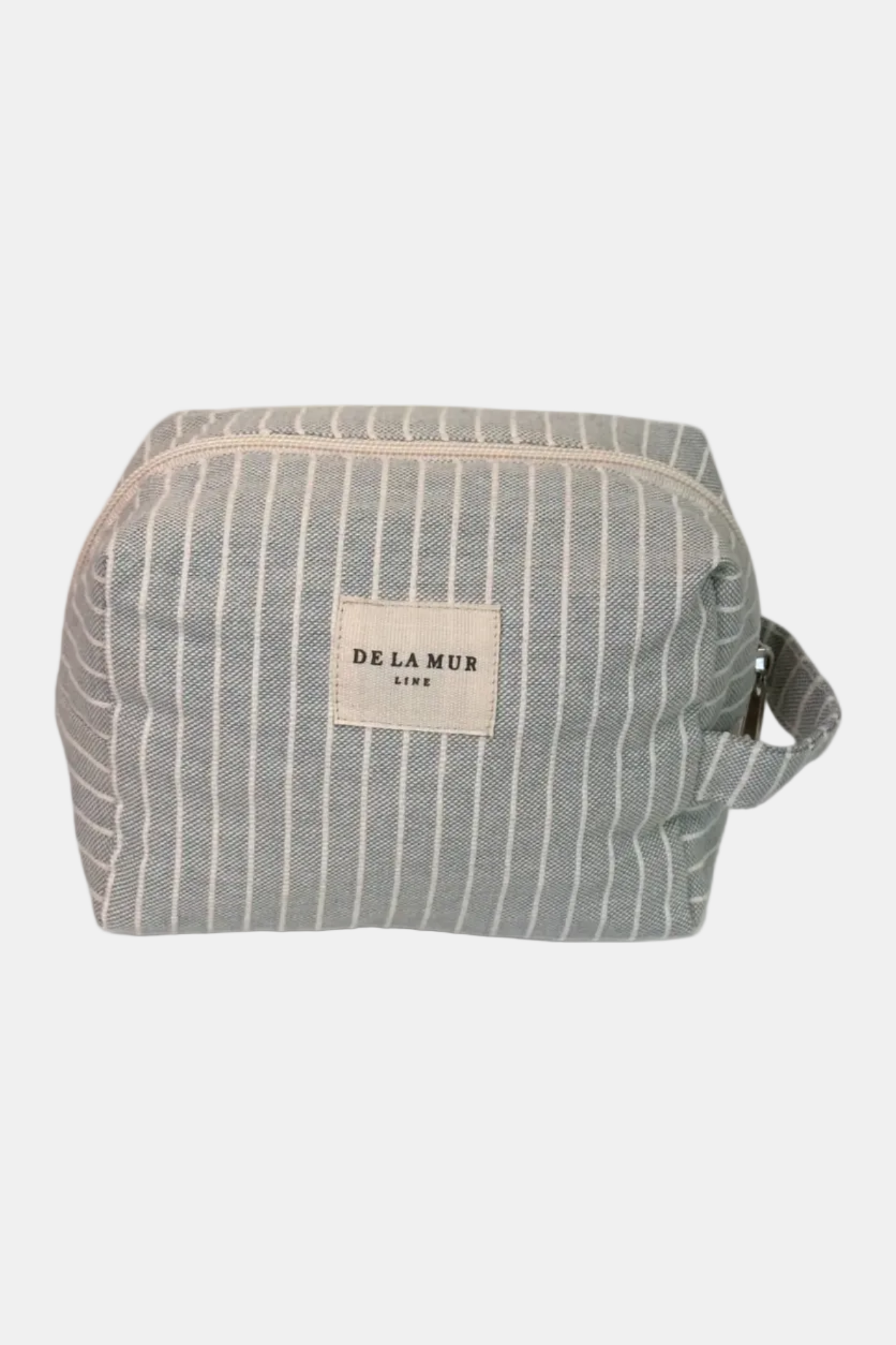 Striped toiletry bag with 'De La Mur' label on a white background