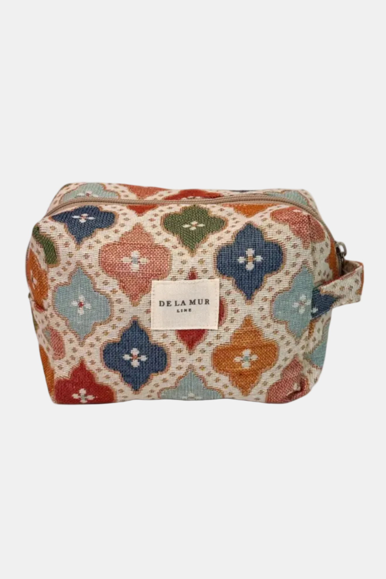 Patterned toiletry bag with 'De La Mure' label on a white background