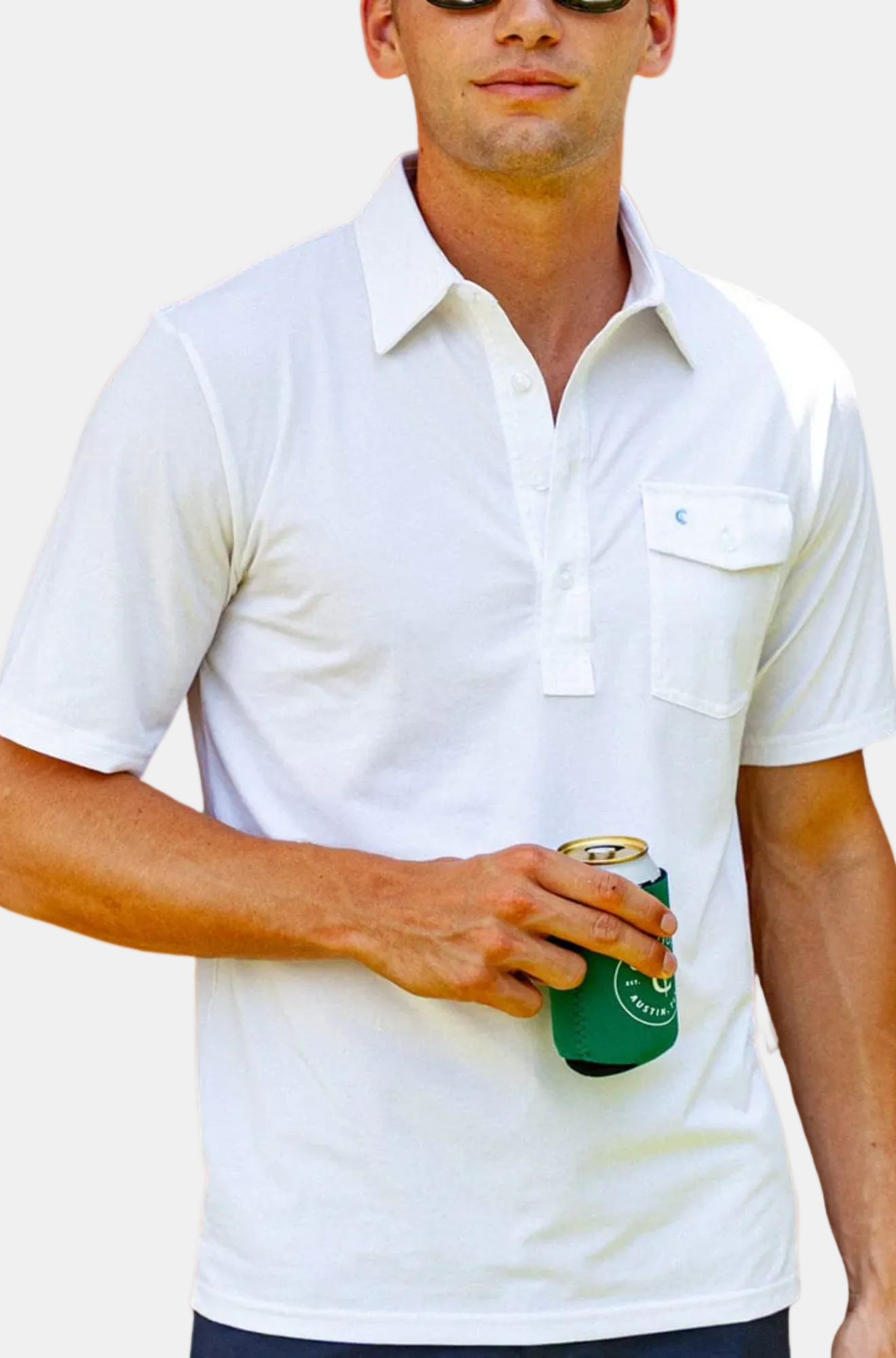 Man wearing a white polo shirt holding a green can against a white background