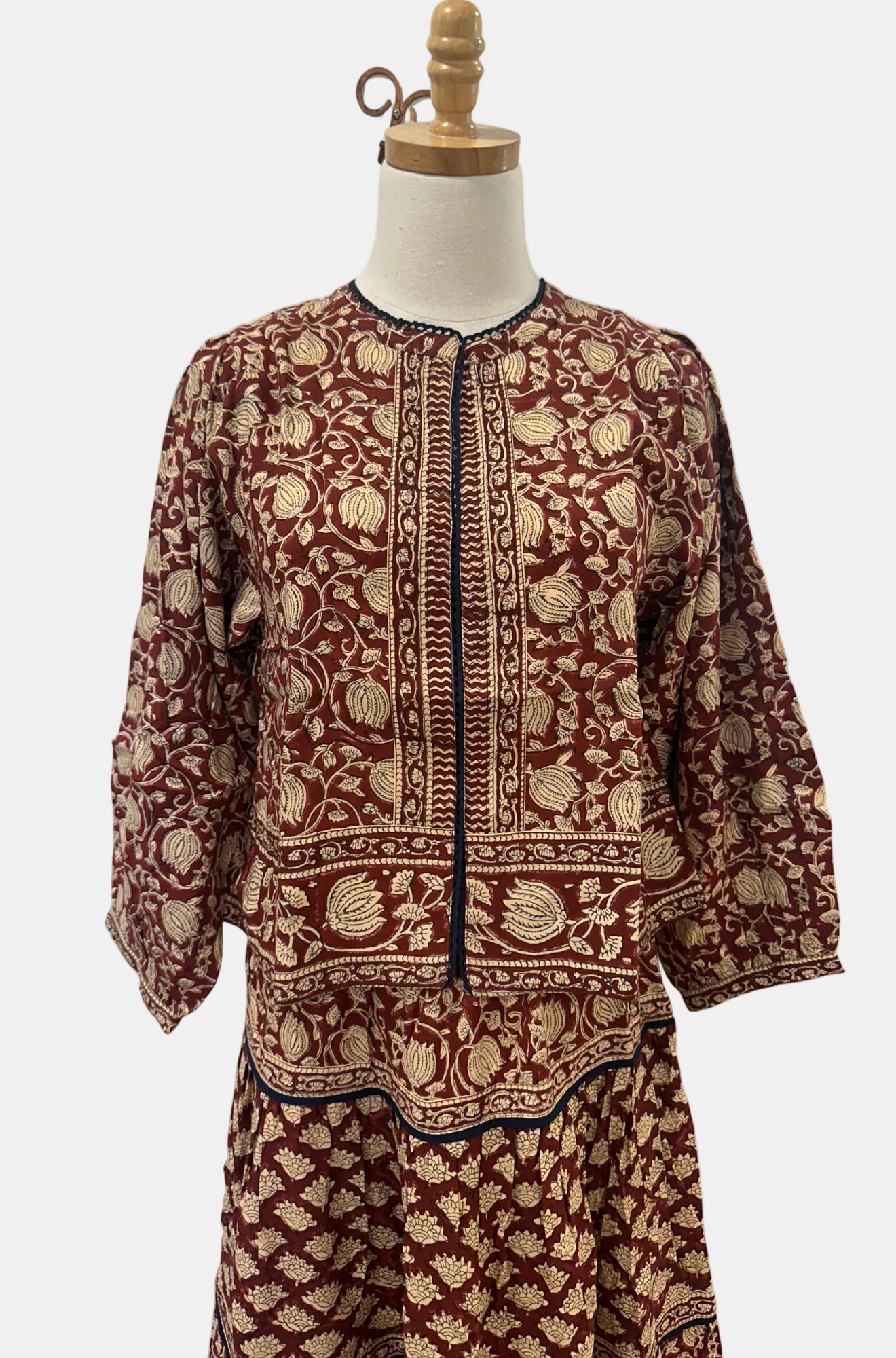 Traditional patterned outfit on a mannequin against a white background