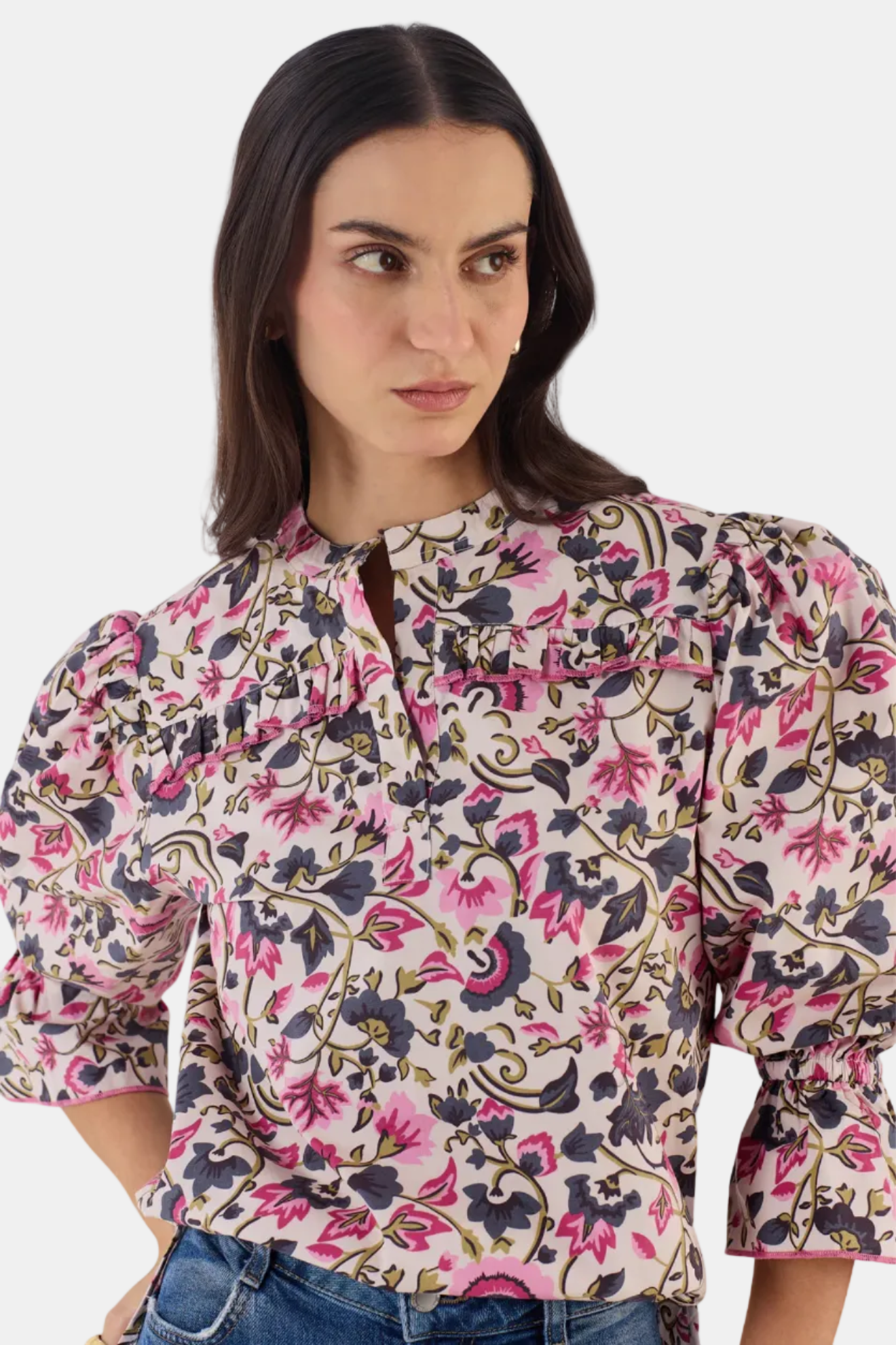 Woman wearing a floral blouse with a white background