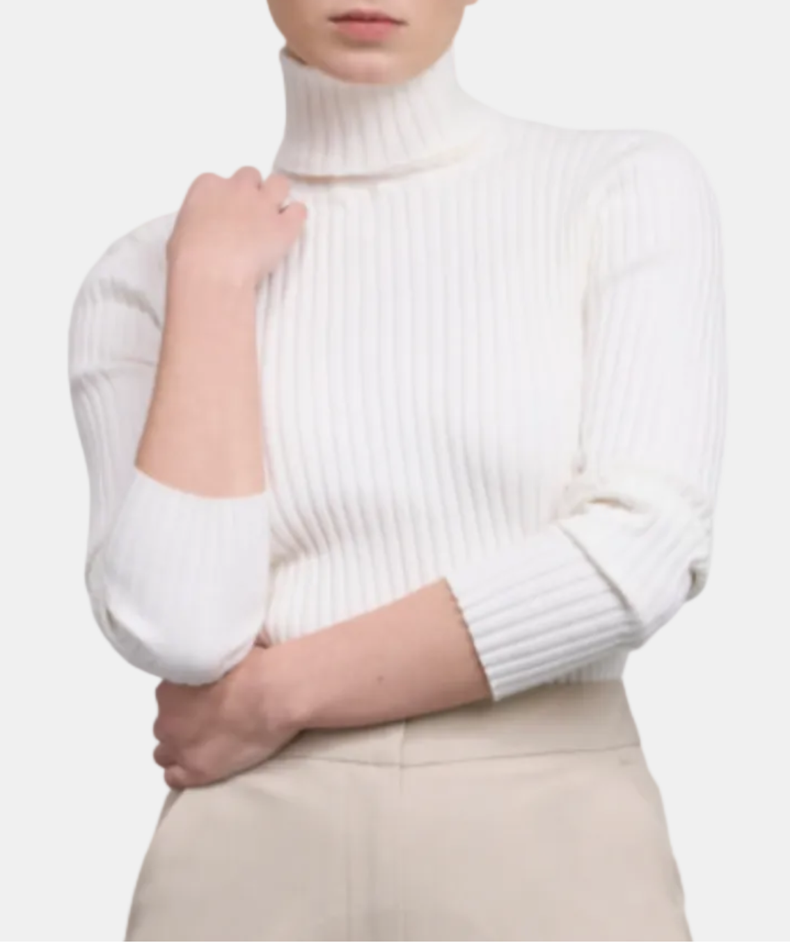 Woman wearing a white turtleneck sweater on a white background