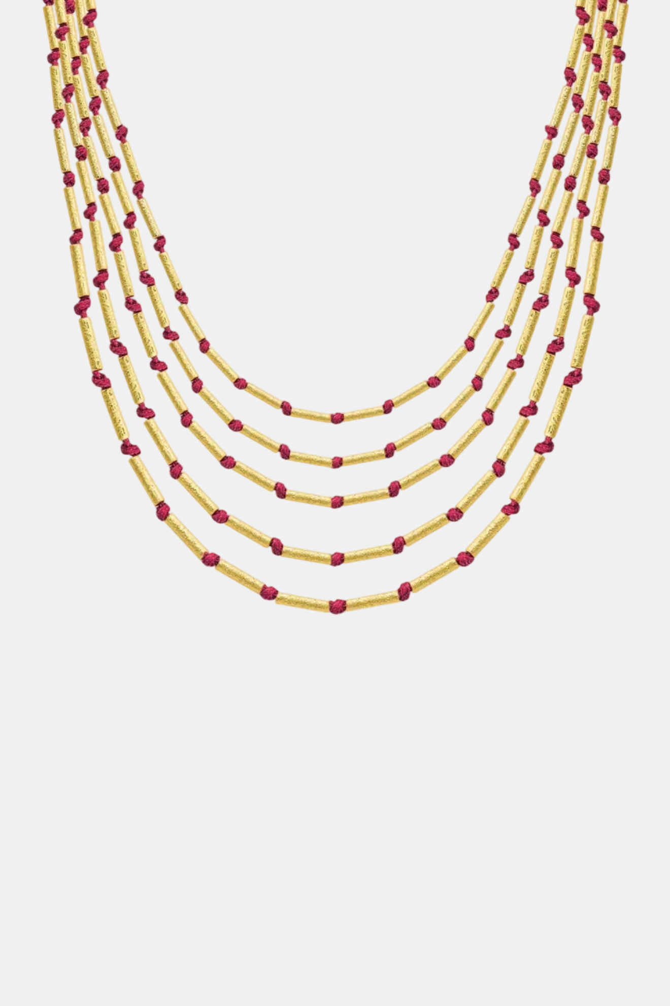 Multistrand necklace with yellow and red beads on a white background