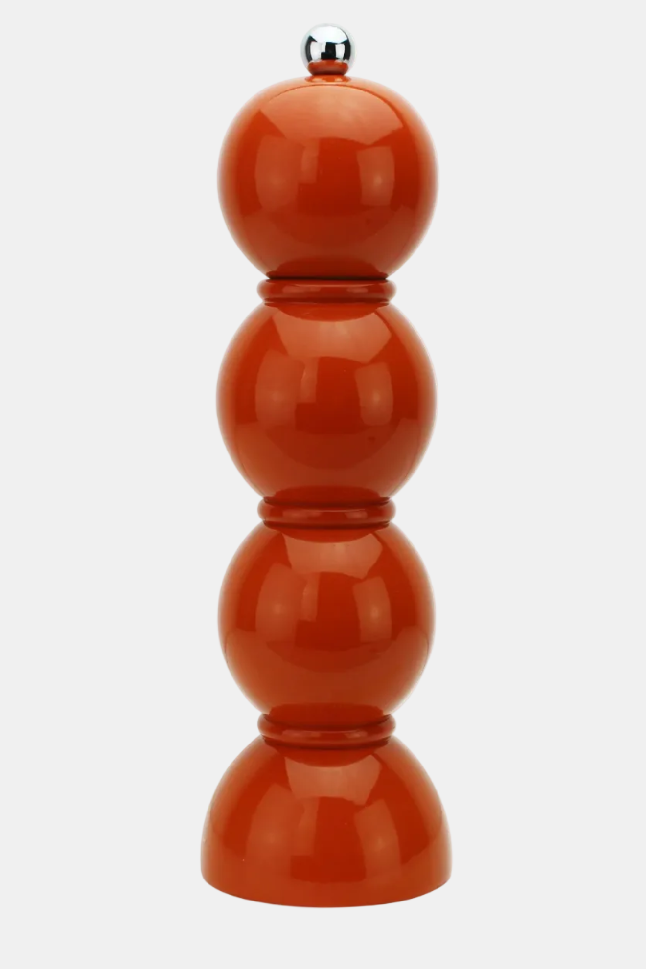 A glossy terracotta orange pepper mill with a stacked four-bulb design and a polished silver metal top, shown against a plain light gray background.