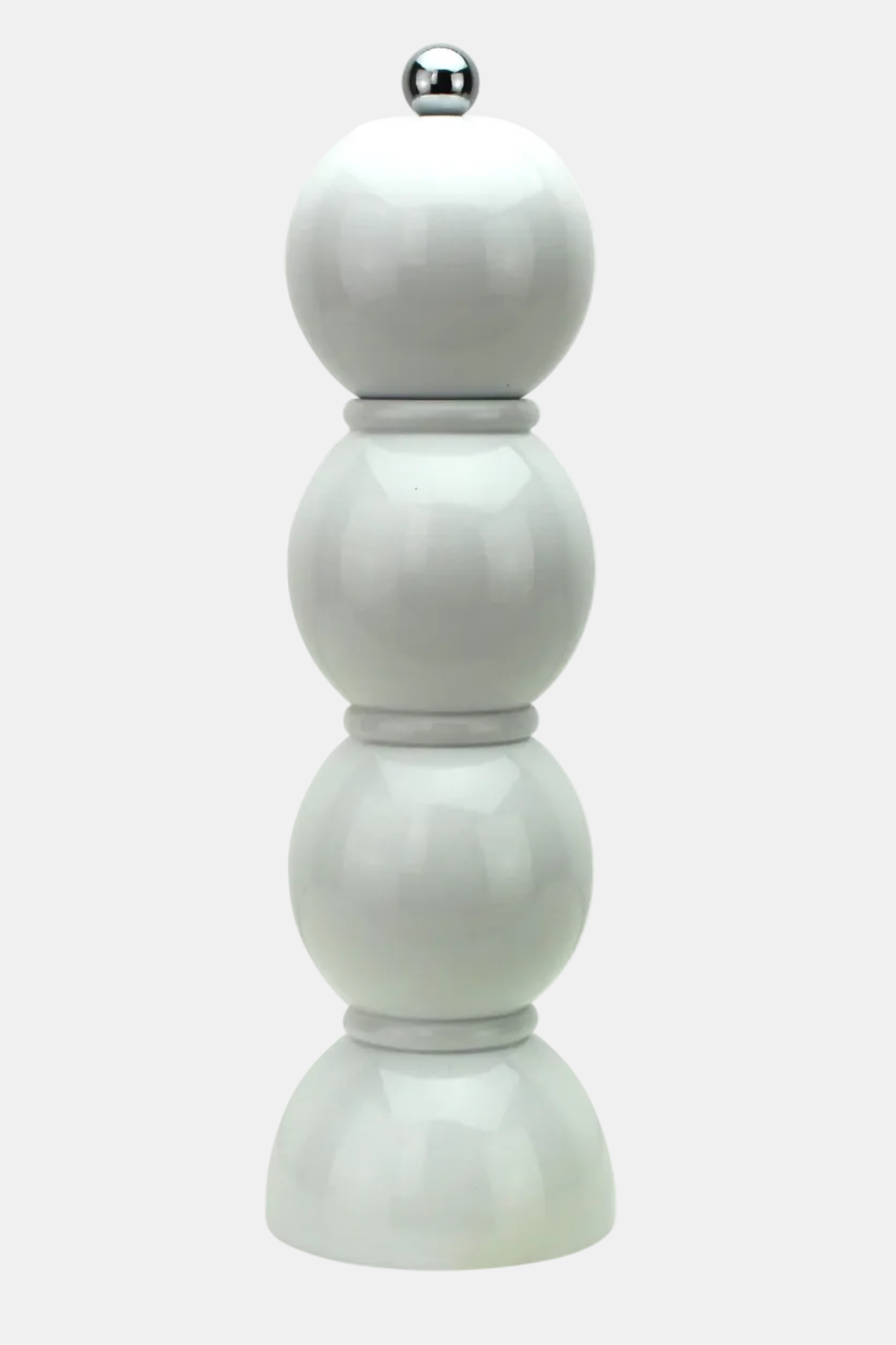 A modern, minimalist white ceramic pepper mill featuring a stacked, spherical design with a polished silver metal ball on top, set against a plain white background.