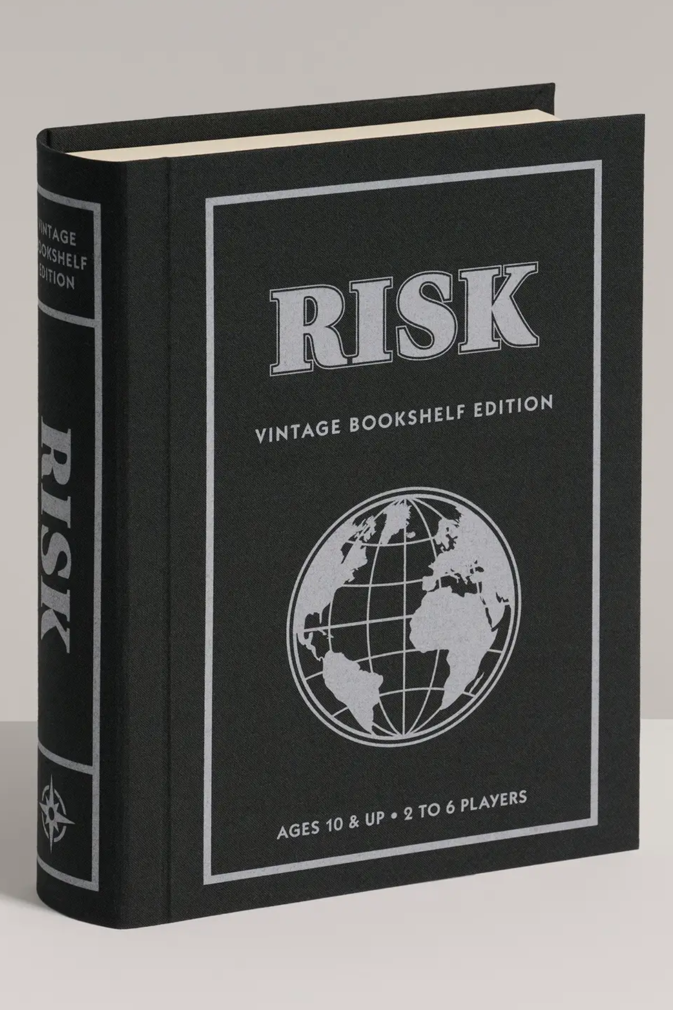 Black book titled 'Risk' with a globe illustration on a gray background