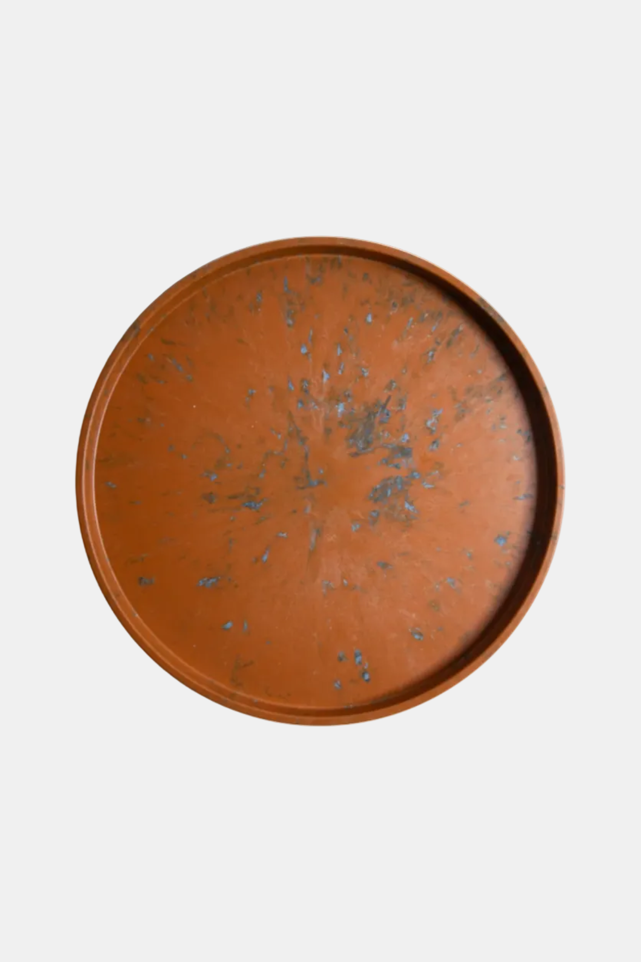 Round brown tray with a textured surface on a white background