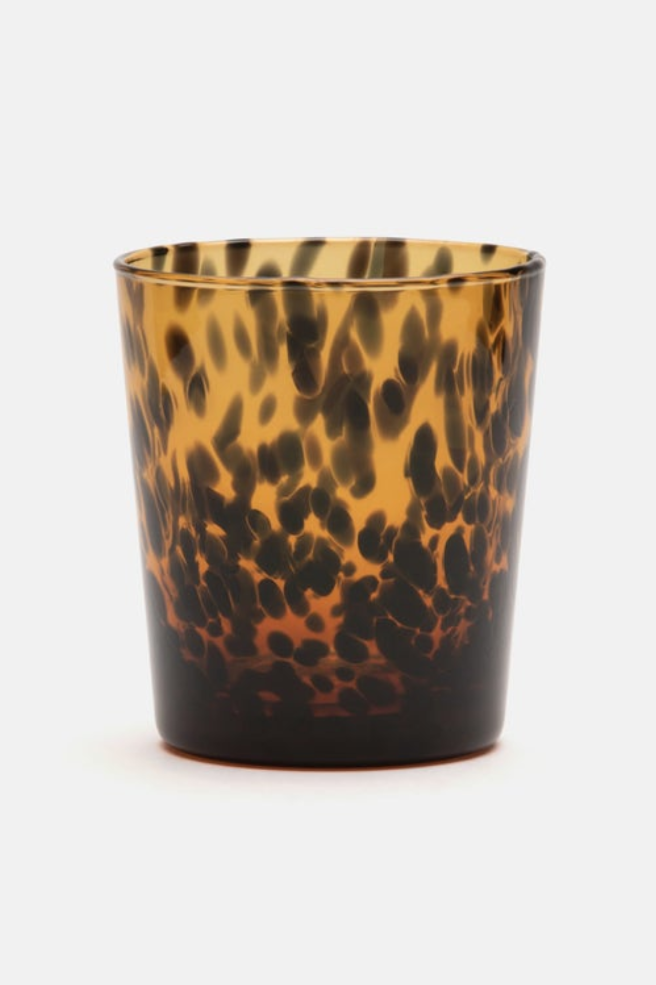 Tortoiseshell-patterned glass on a white background