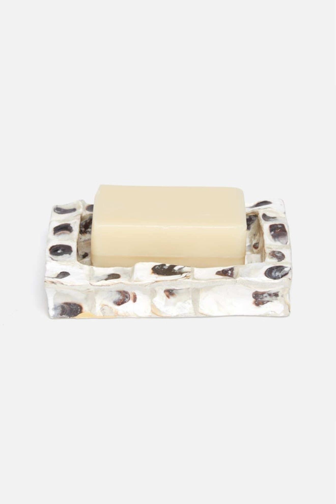 Soap dish with a bar of soap on a white background