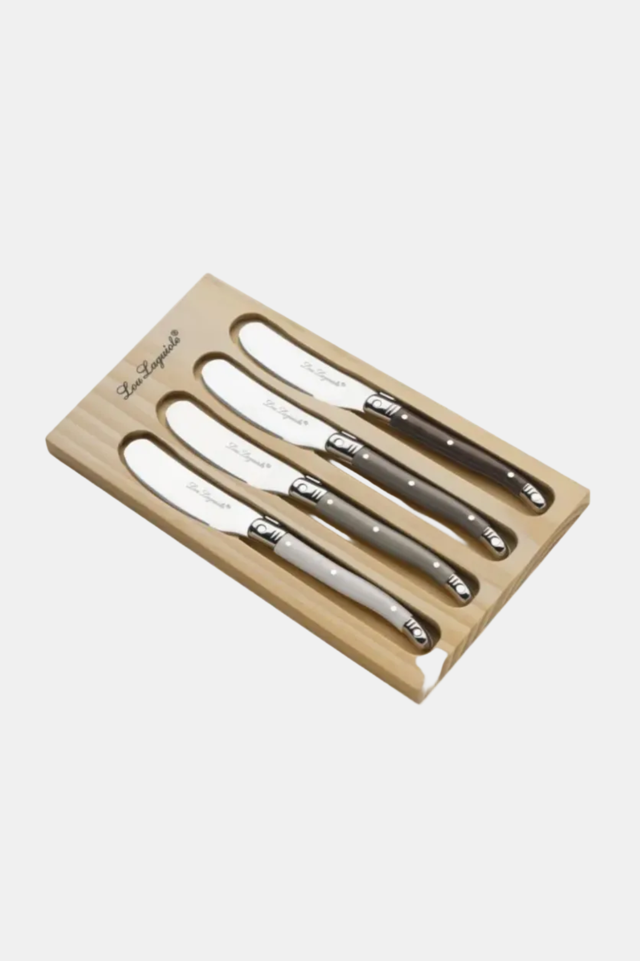 Set of four steak knives in a wooden holder on a white background