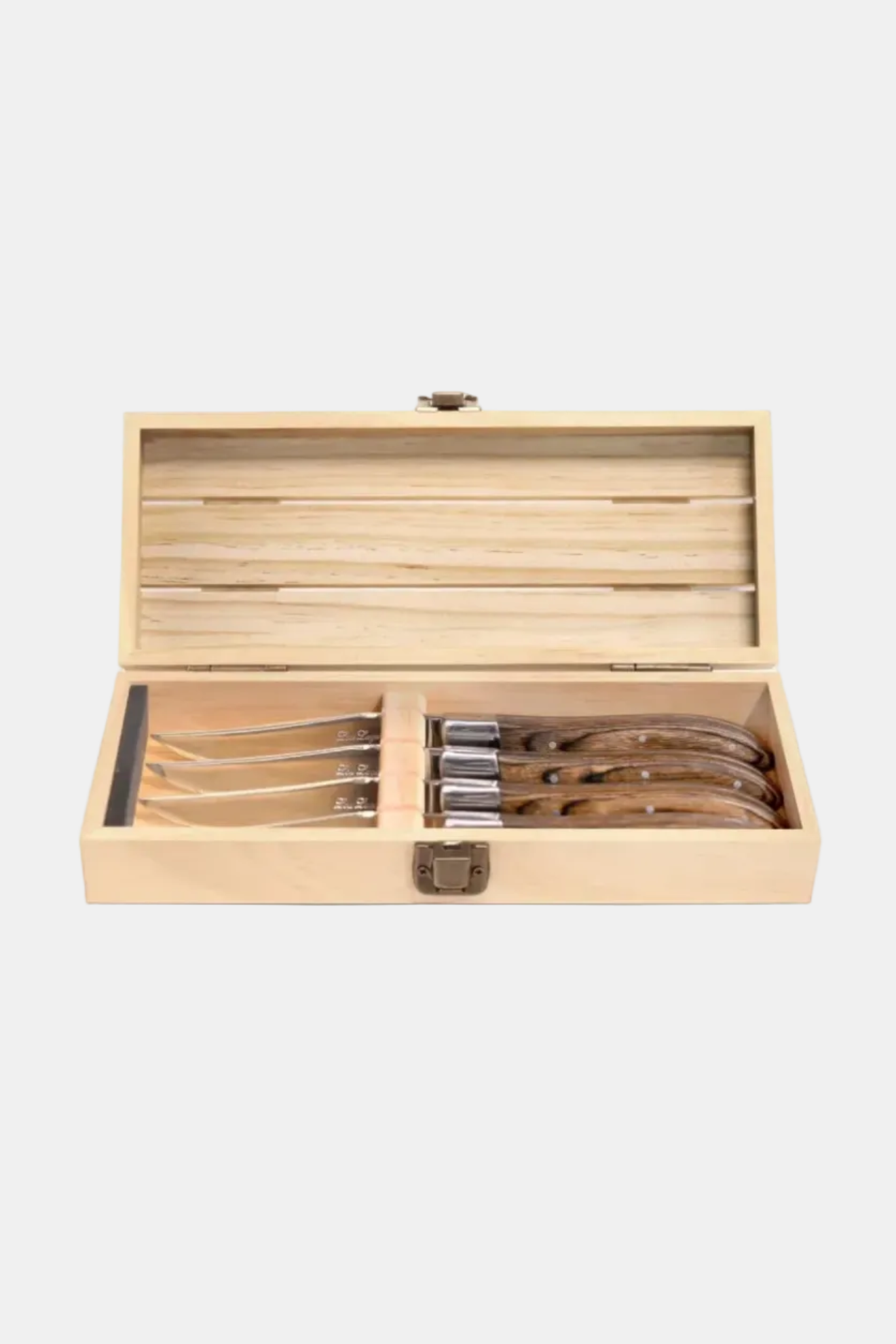 Set of steak knives in a wooden box on a white background