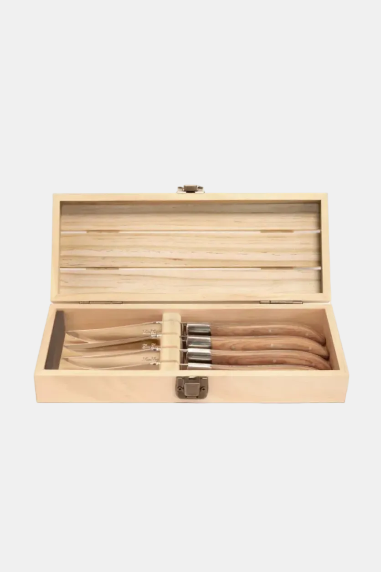 Set of wooden utensils in an open wooden box on a white background