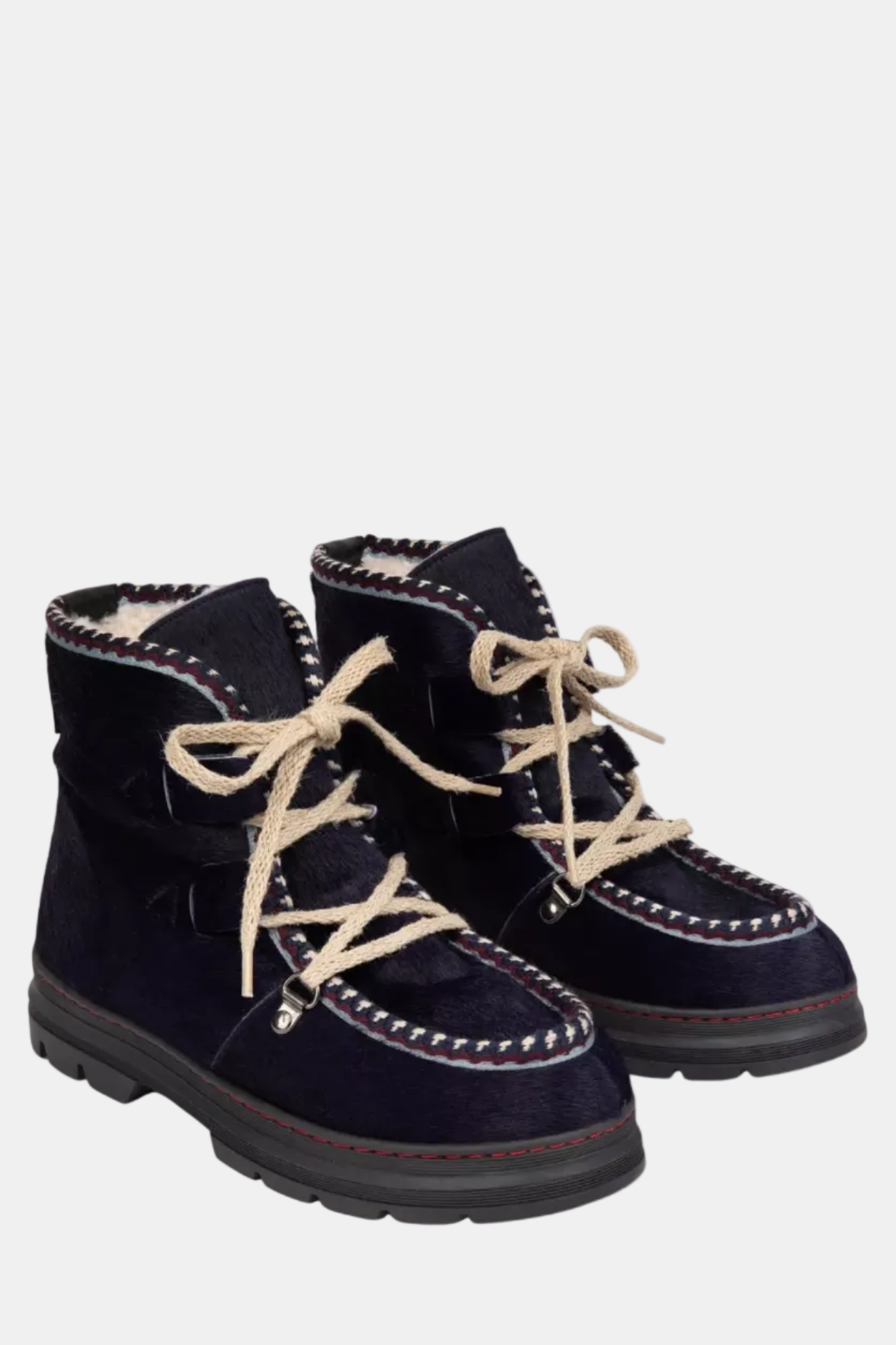 Pair of navy blue winter boots with beige laces on a white background