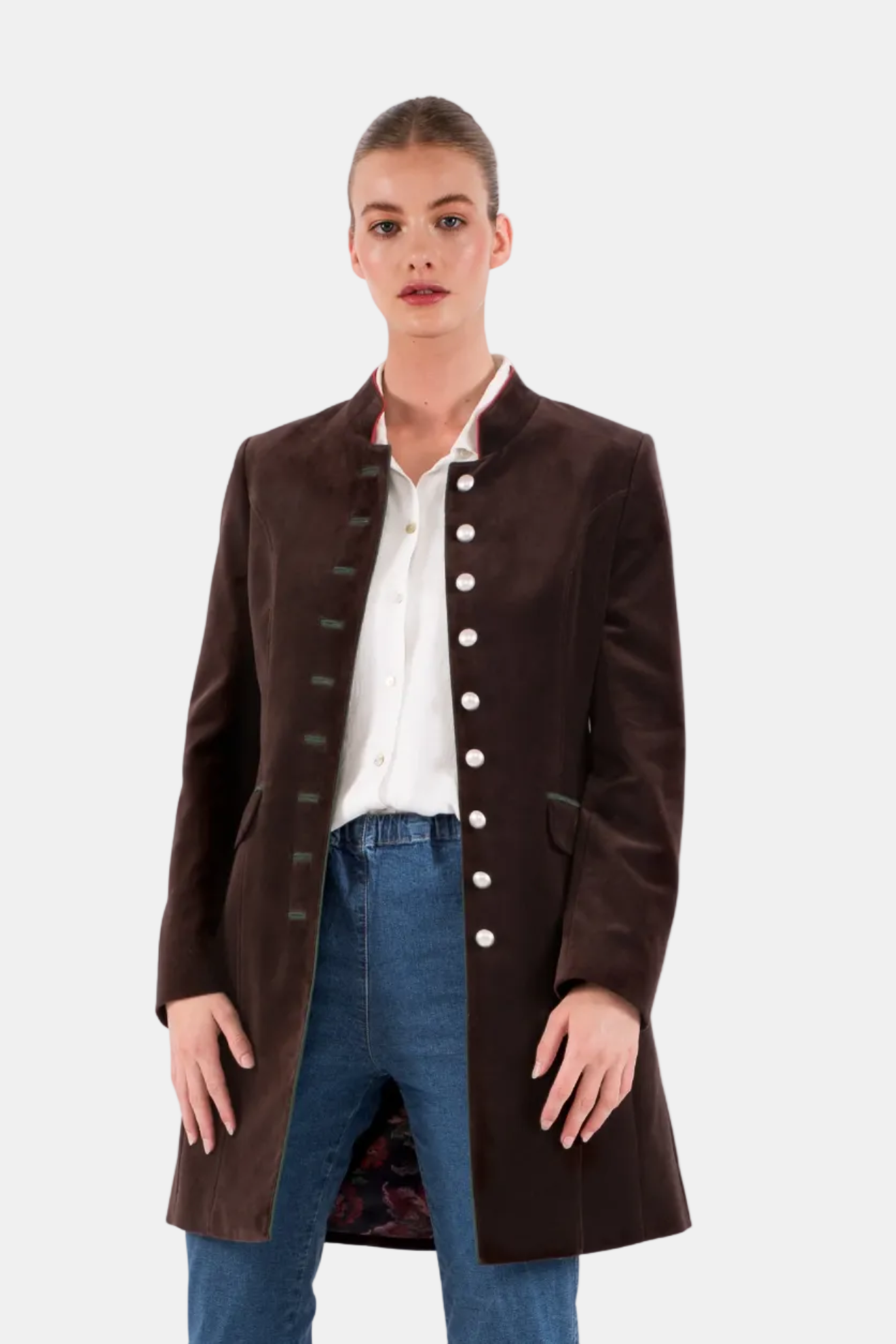 Woman wearing a brown coat with white buttons on a white background