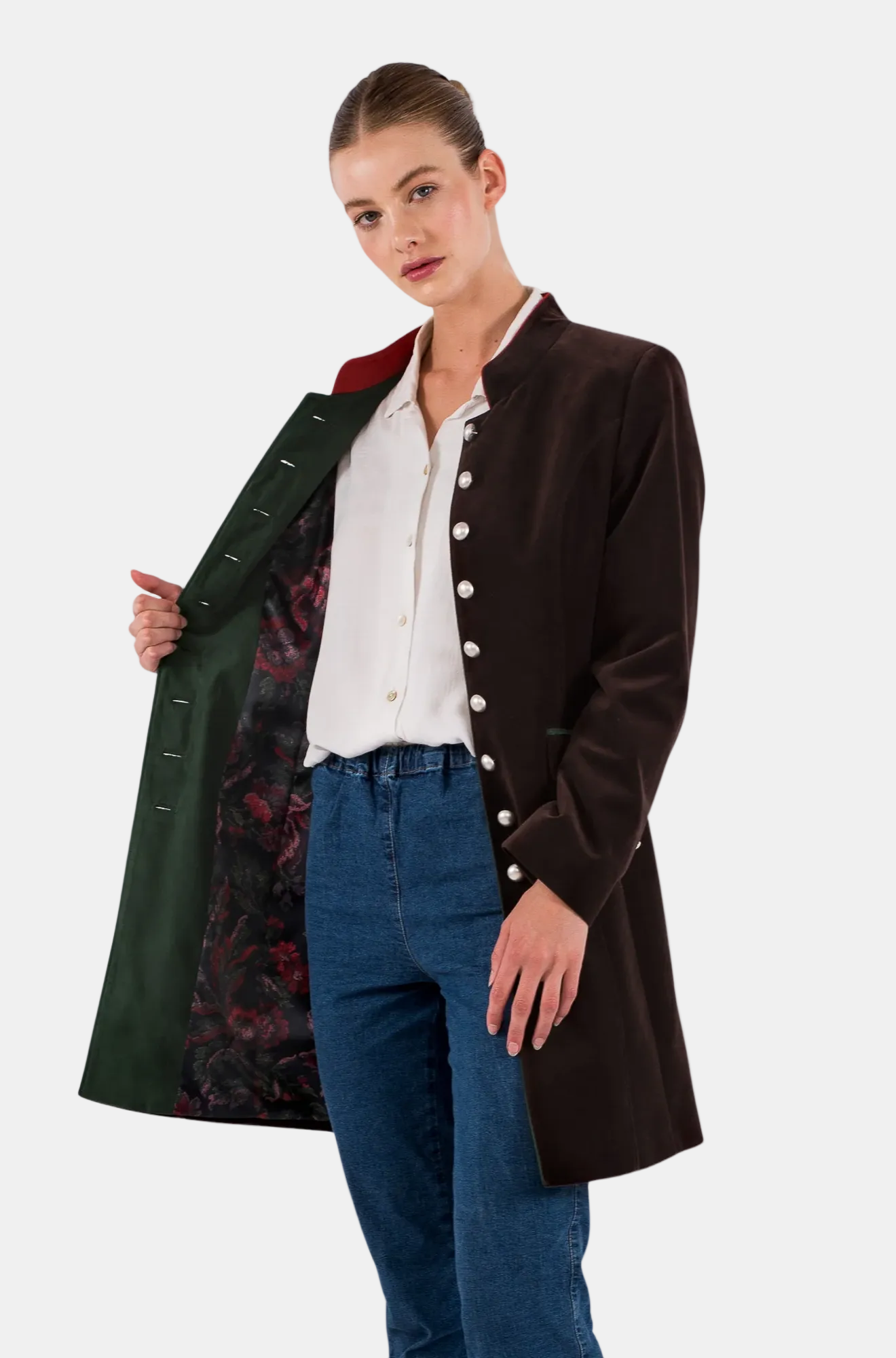 Woman wearing a dark brown coat with a green lining, white shirt, and blue jeans on a white background